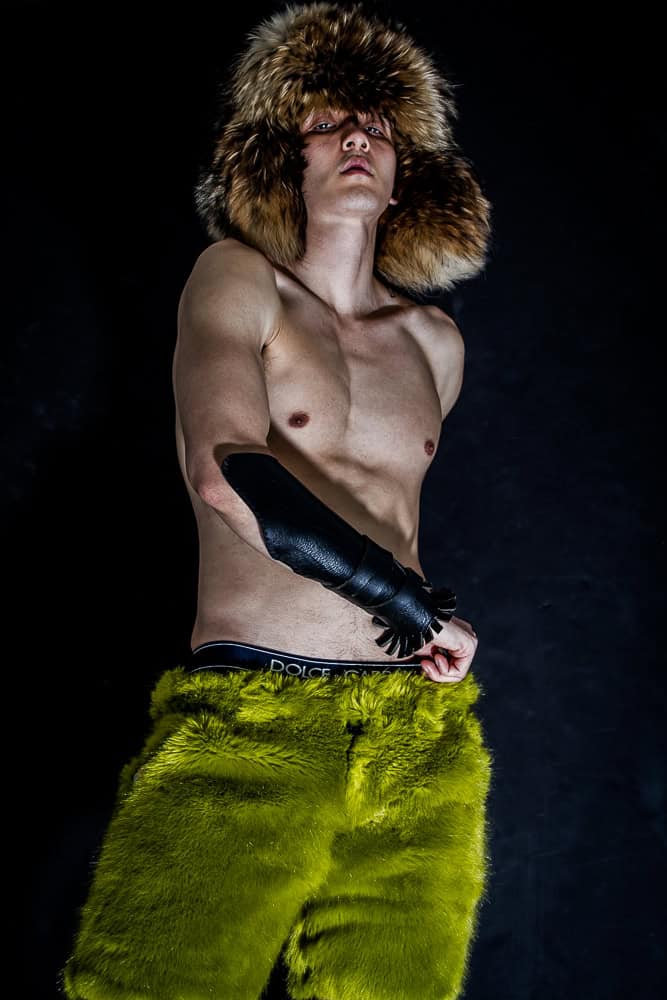 Underground Club Kid wearing Racoon Fur hat Marc Jacobs, Beast Shorts by Brian Swift, leather elbow length arm wrap by Robert Calasanz

