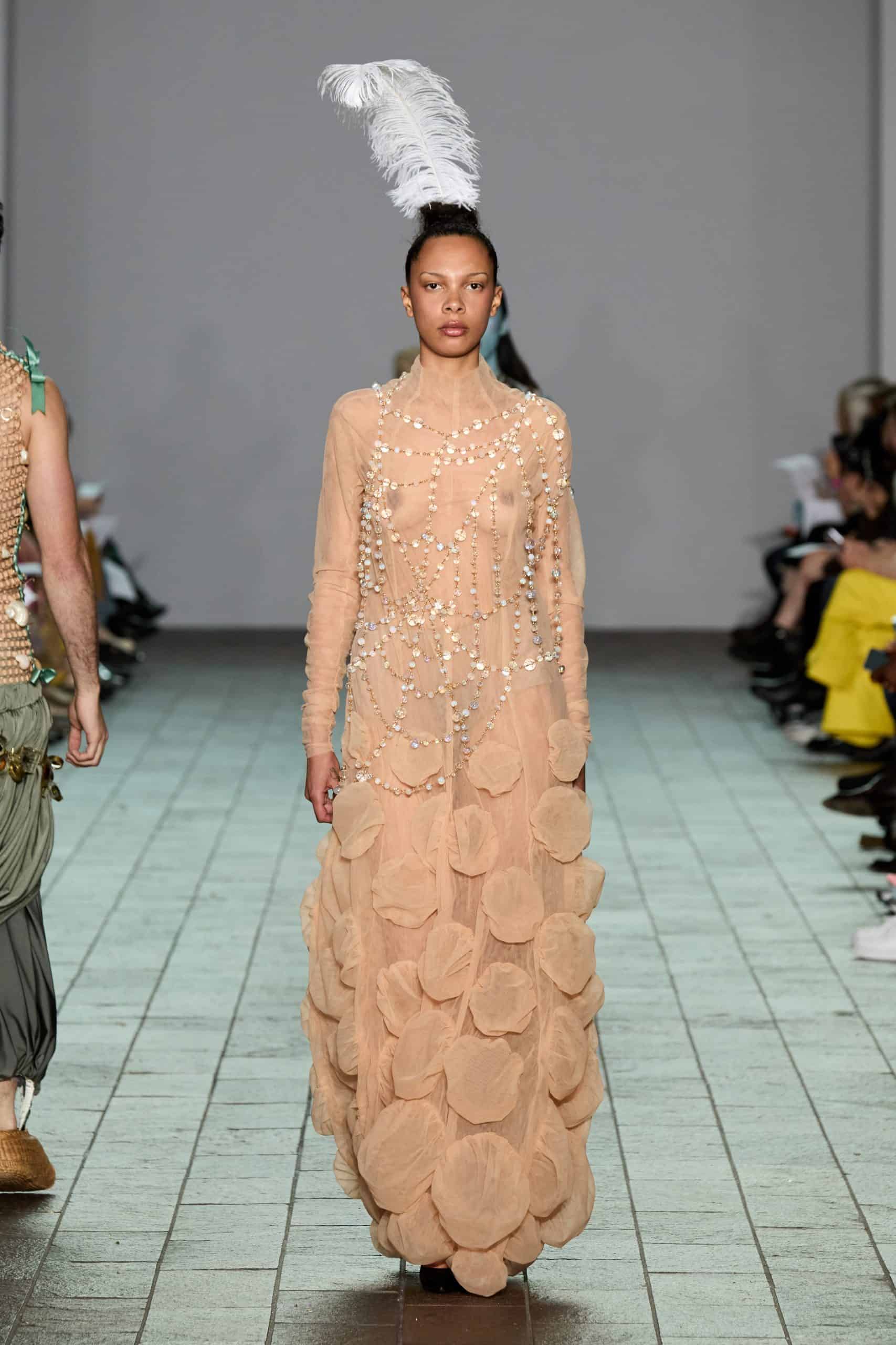 Model wearing a peach-toned dress adorned with pearls and a single feathered headpiece from Anton Femia’s collection. Courtesy of the designer, Anton Femia.