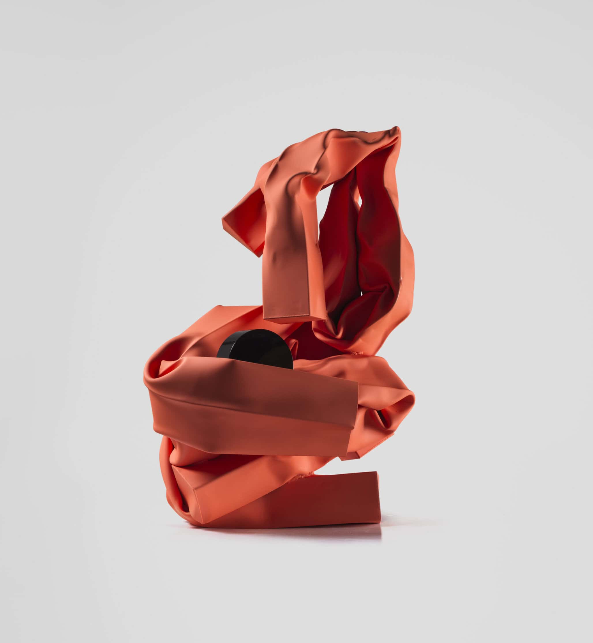 Abstract sculpture with red and black ribbons displayed at the Guggenheim Museum.