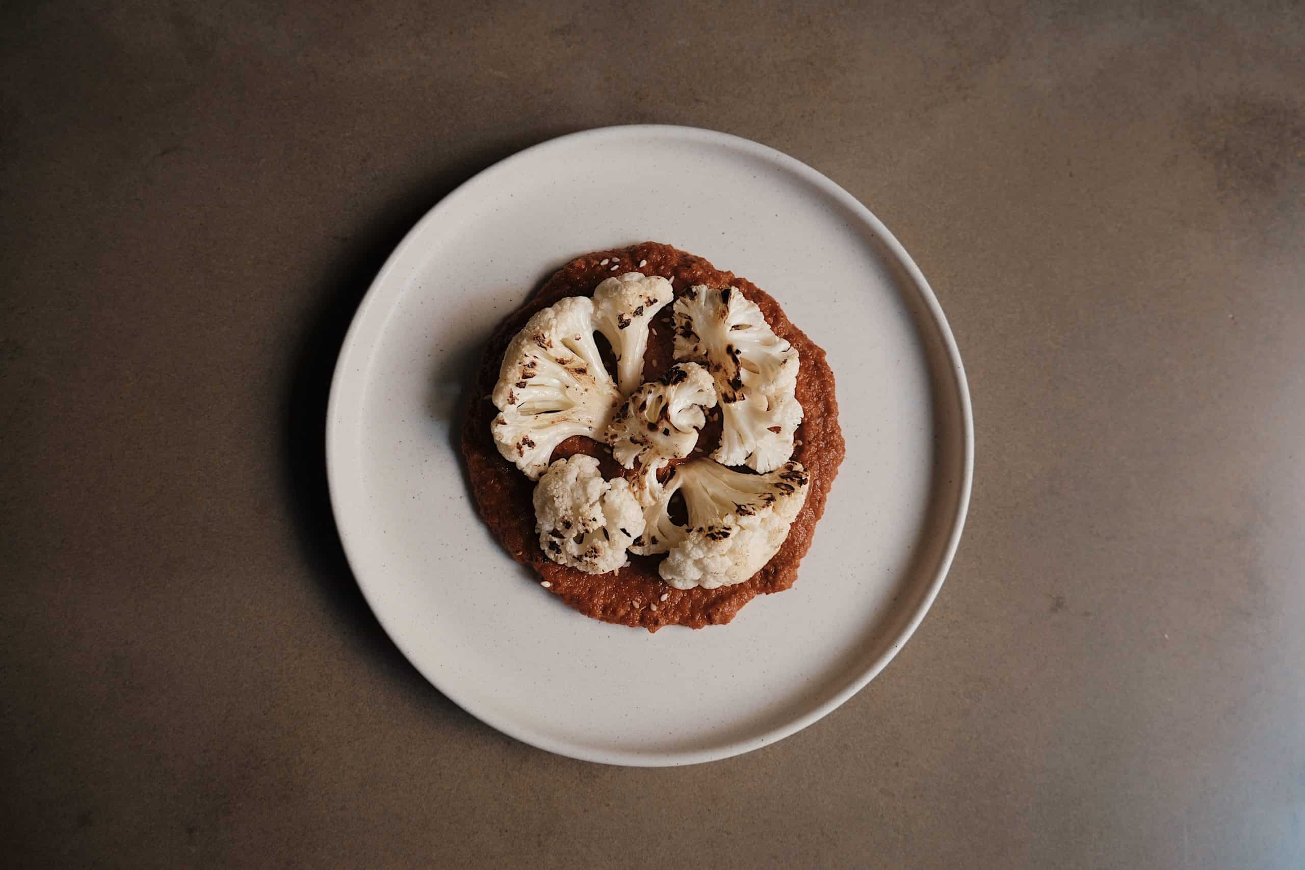 Charred cauliflower on a stone plate 