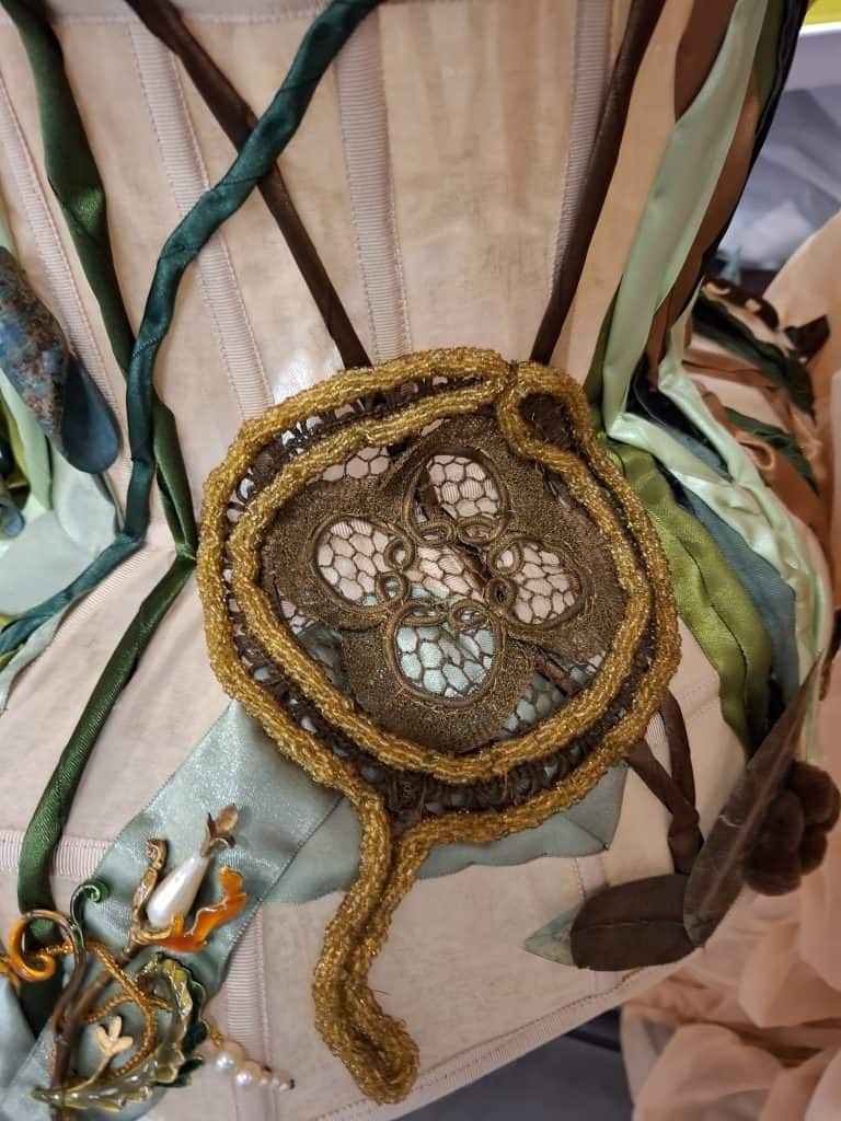  Embroidered detail from Anton Femia’s garment, showing a medallion-like patch surrounded by textured ribbons and organic stitching. Courtesy of the designer, Anton Femia.