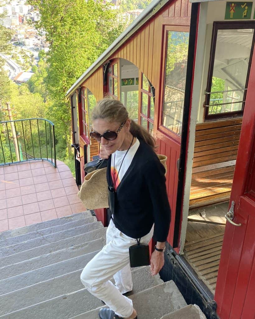 Sigrid de l’Epine boarding a vintage red train in countryside