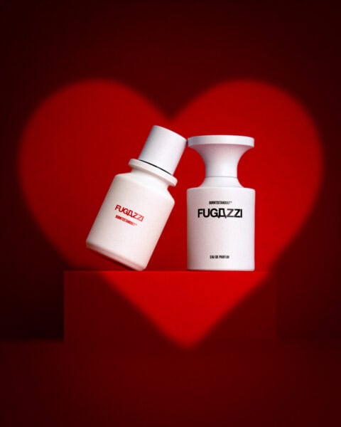 FUGAZZI and BORNTOSTANDOUT perfume bottles on a red background with heart shape.