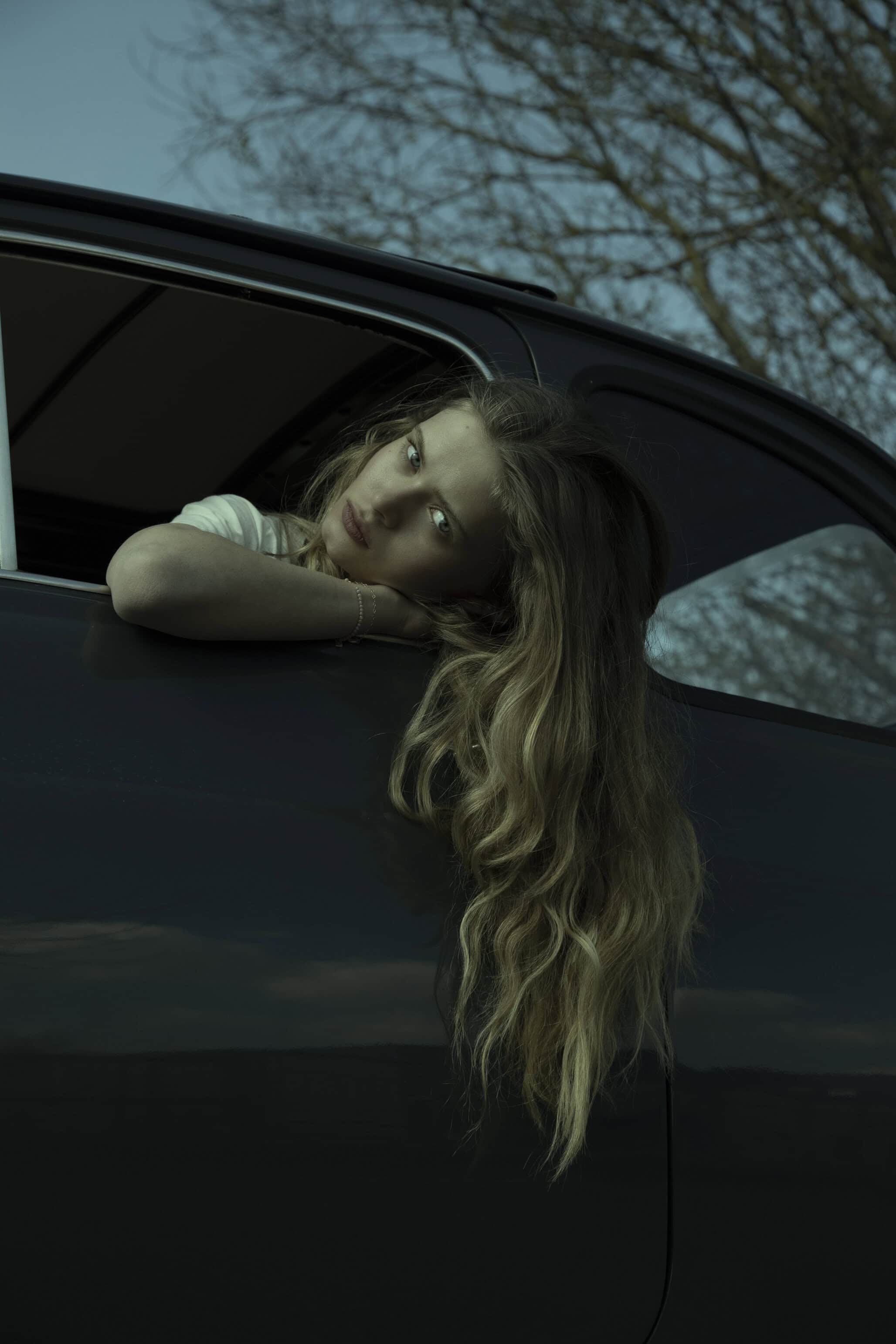 Beautiful girl in car in Dress Valentine Gauthier, bracelet Ginette Paris