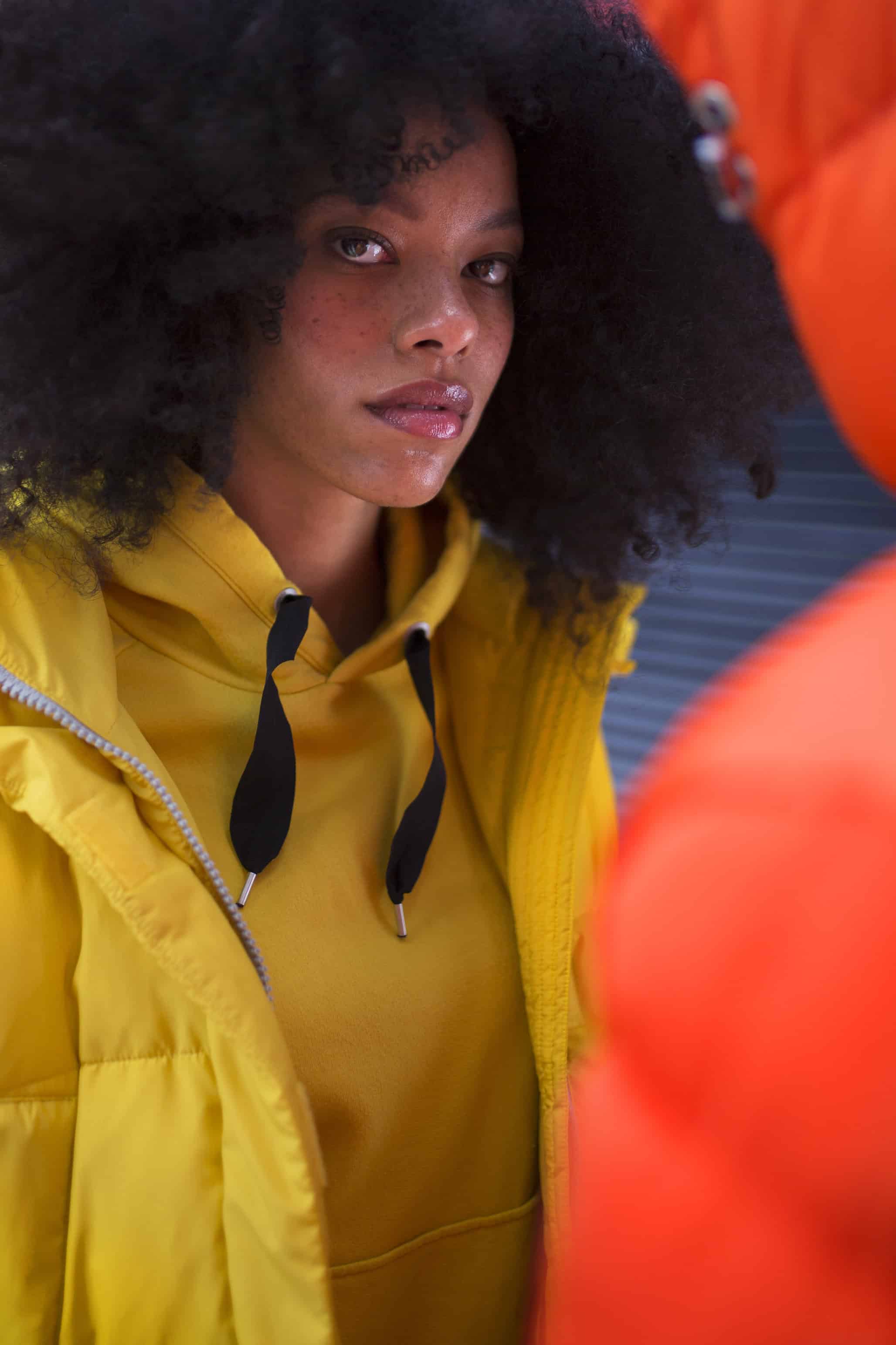 White & navy shoes BORDEN, yellow sweatshirt & bright yellow puffy jacket LEE. Him: Orange puffy jacket SWEET PANTS.