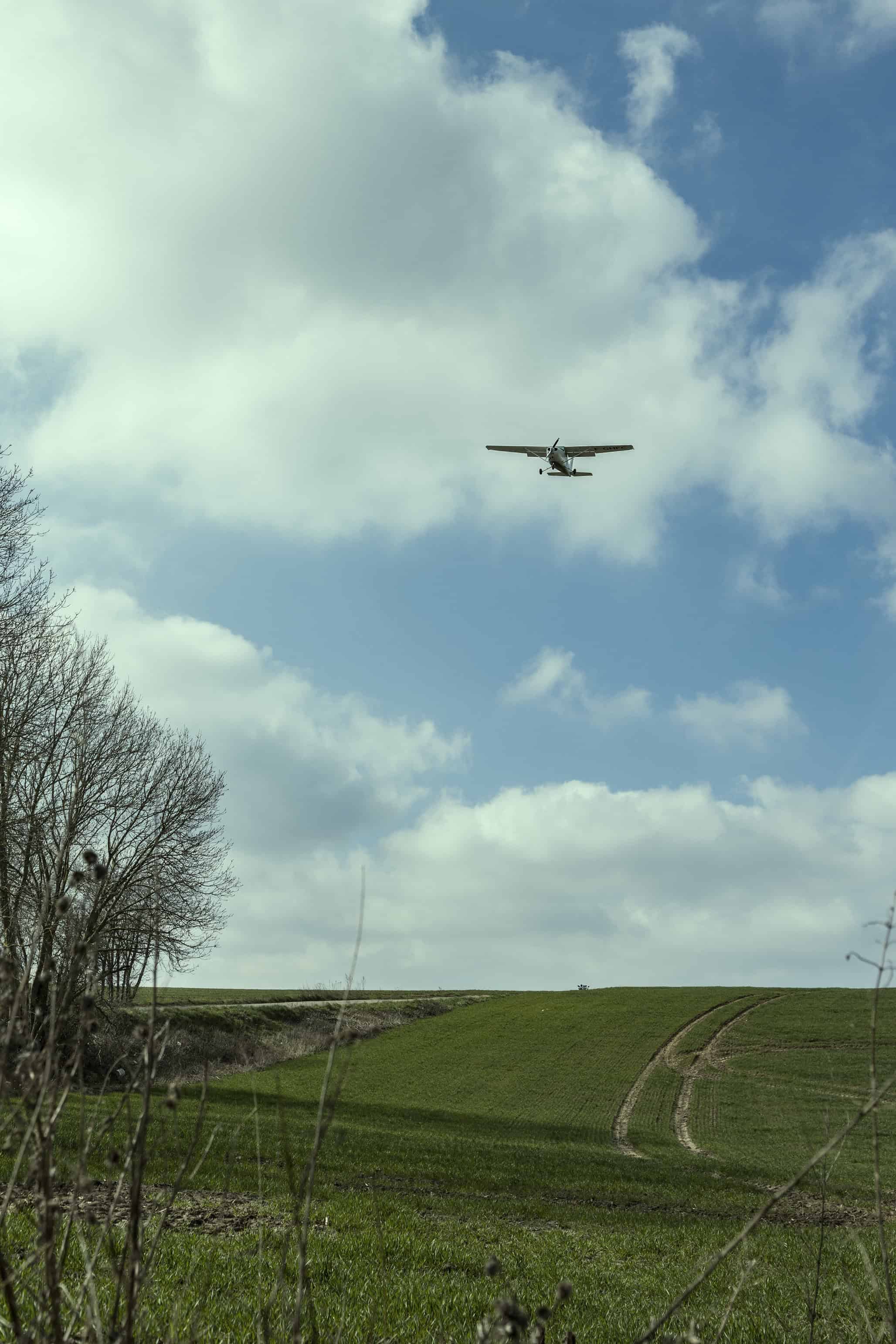 airplane flying over field.  by photographer FRENCH COWBOY A Mia Macfarlane & Julien Crouigneau Creation 
