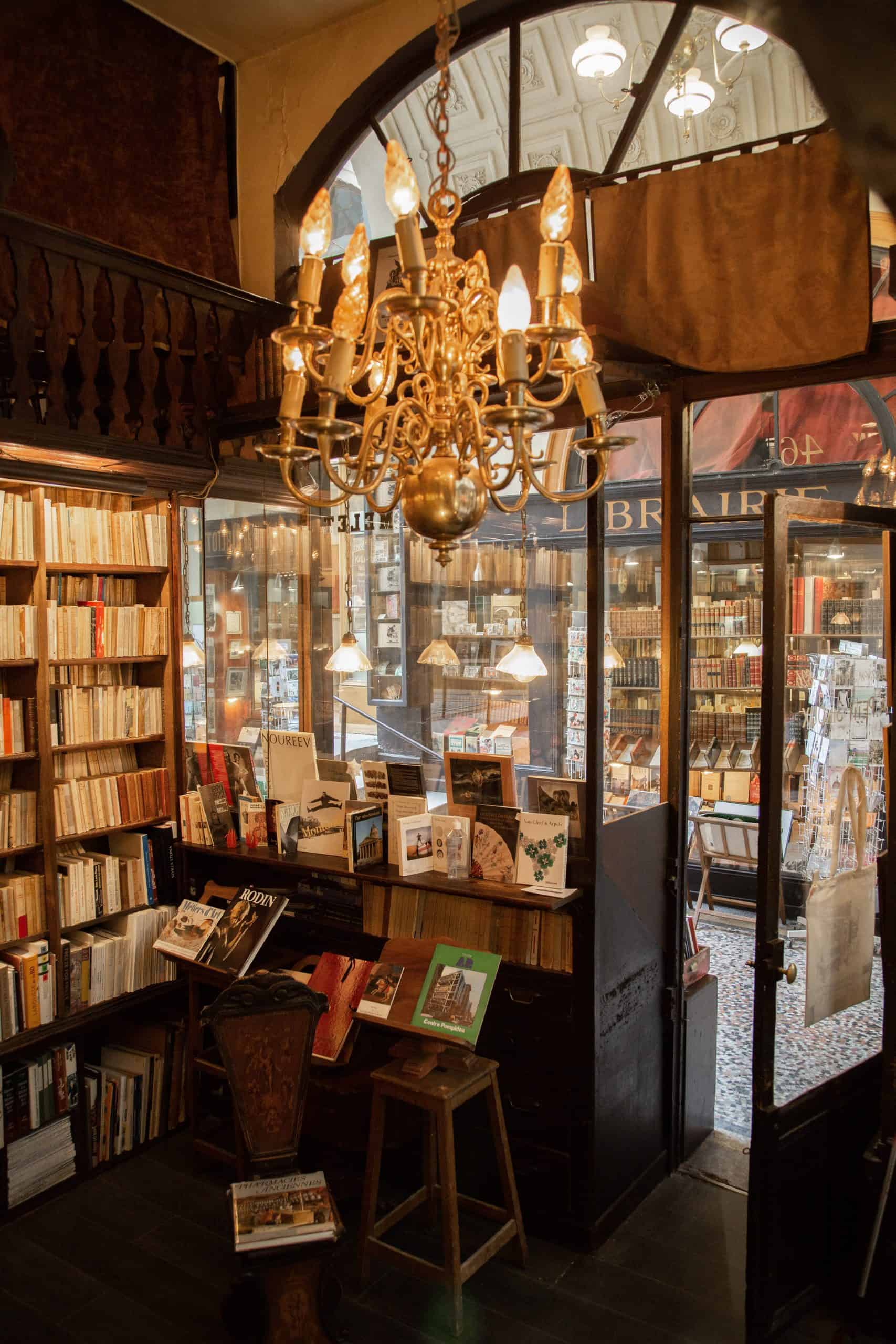 Inside vintage library Jousseaume. With a chandelier, wooden interior and the library display. 