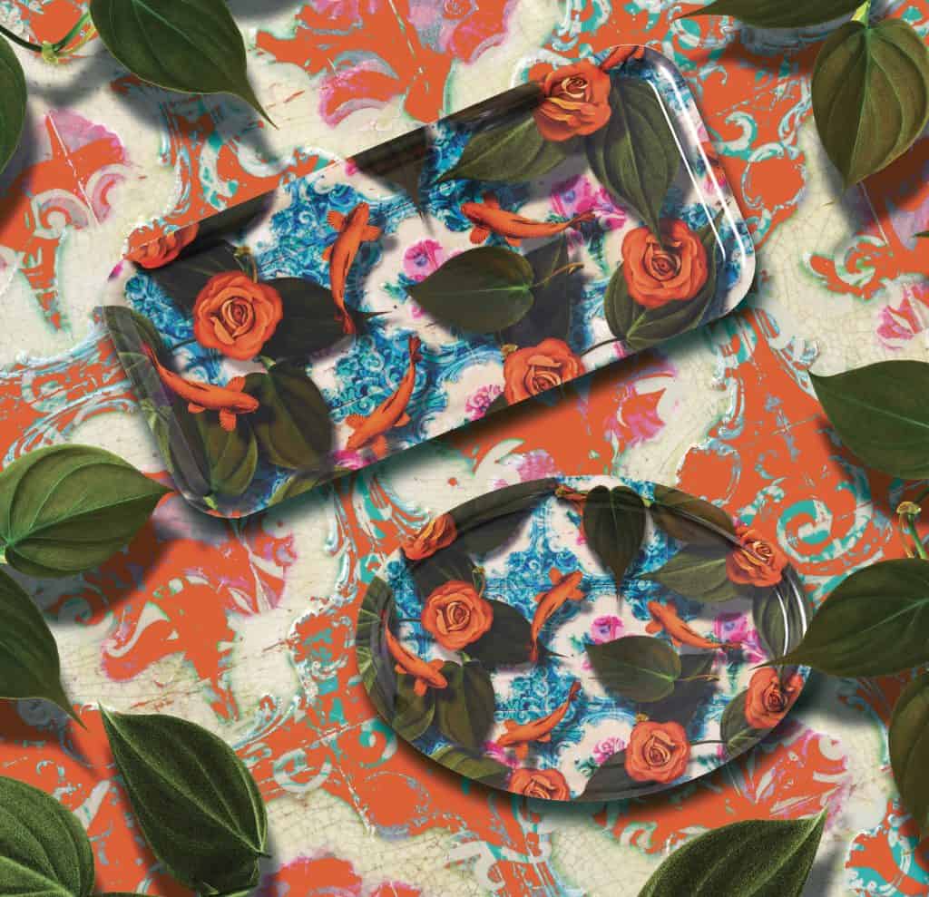 Colorful decorative trays with surreal botanical patterns, including roses, leaves, and vibrant swirls, arranged against a matching floral background.