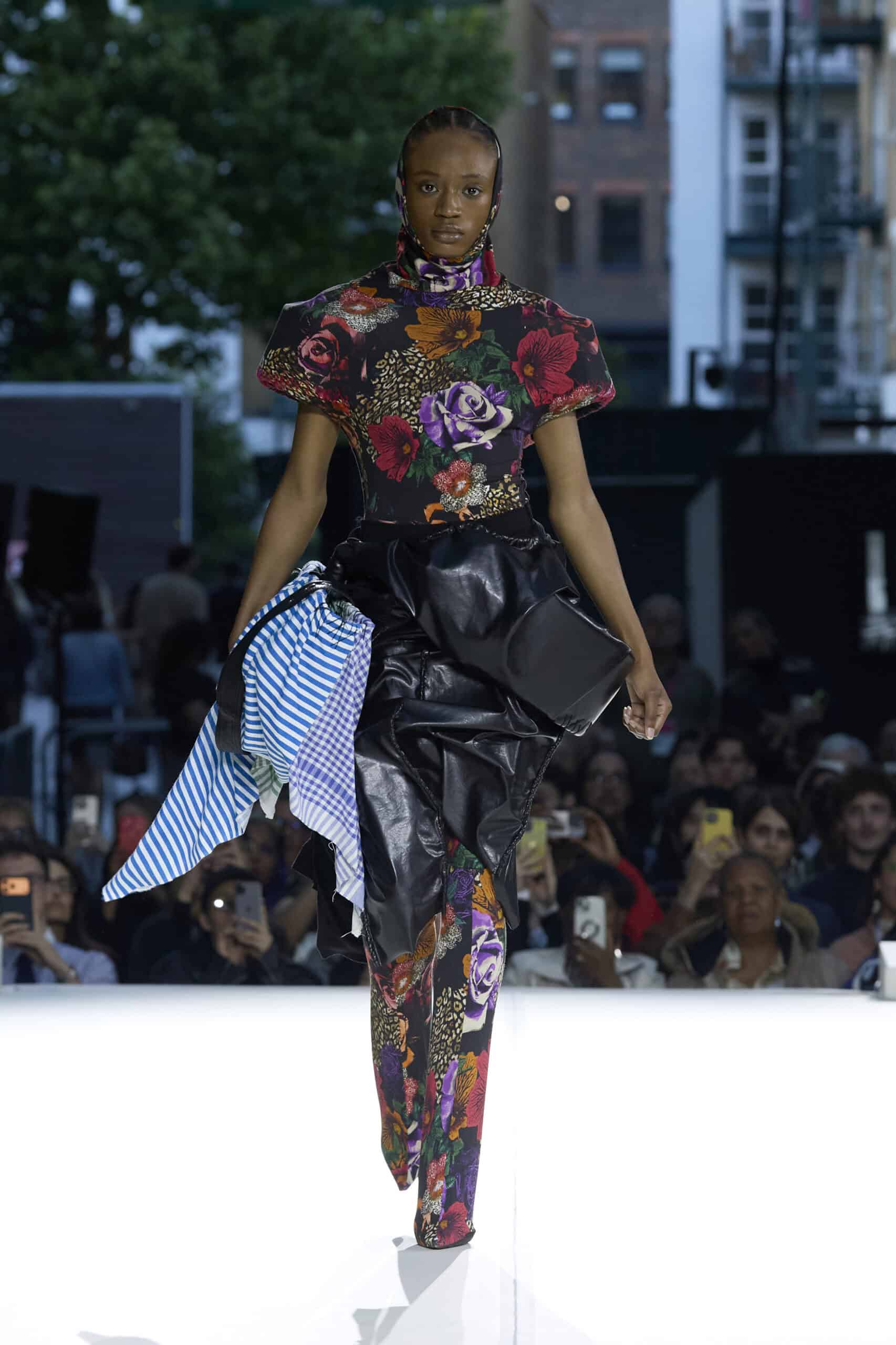 Alt: "Models present collections by emerging designers during the Fashion District Showcase 2026 in London, United Kingdom. The showcase featured work"