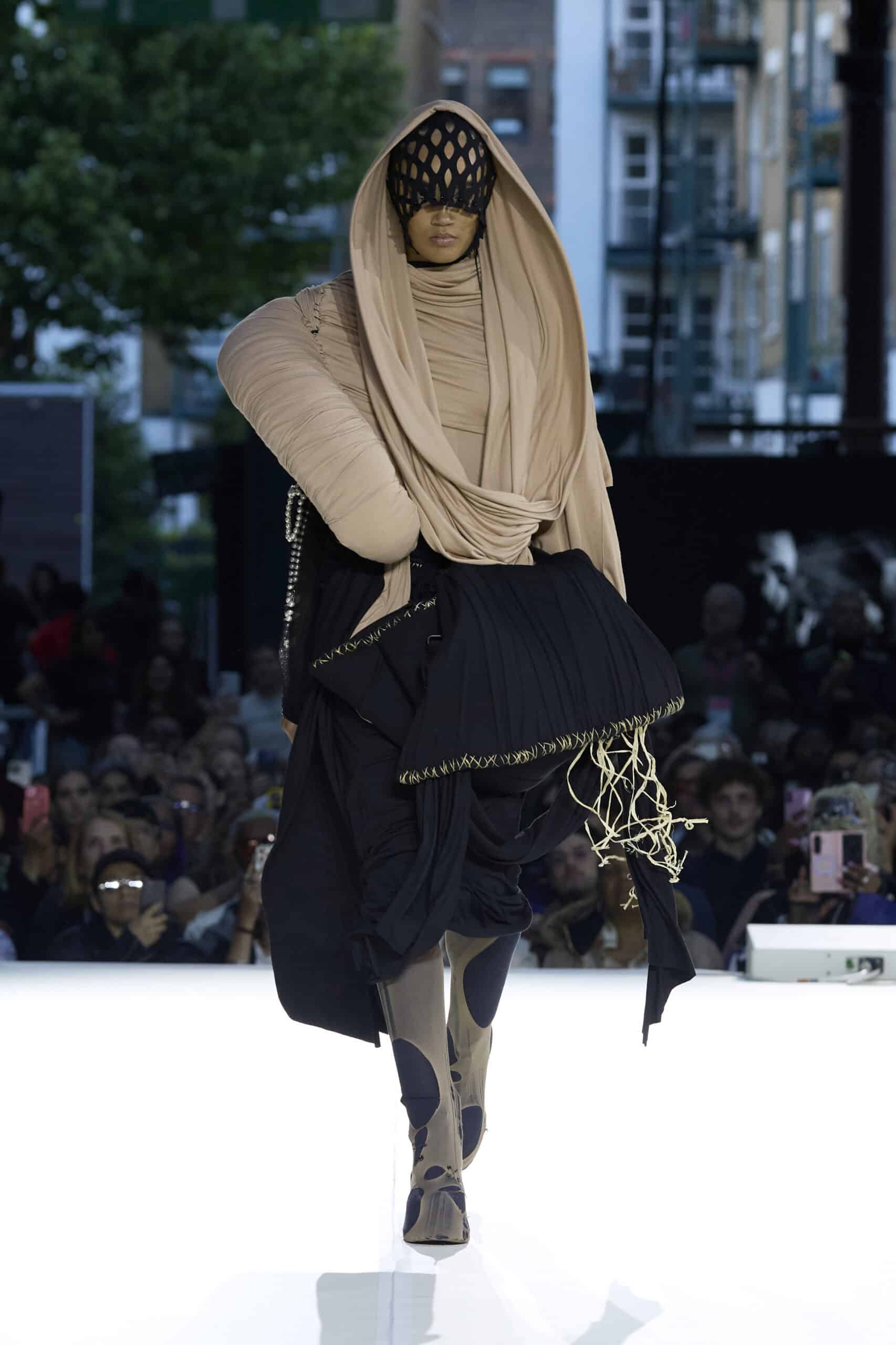 Alt: "Models present collections by emerging designers during the Fashion District Showcase 2026 in London, United Kingdom. The showcase featured work by Barbara Hornok"