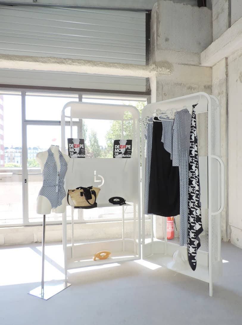 La Malle displayed in industrial space, featuring signature pieces, bags, and folded garments.