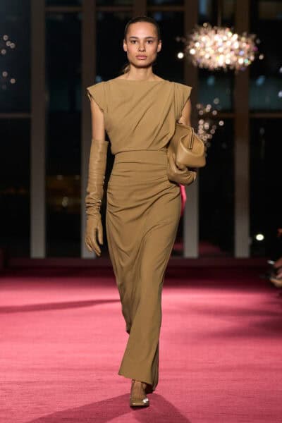 Elegant runway model showcasing Michael Kors Fall/Winter 2026 collection at 45th anniversary event.