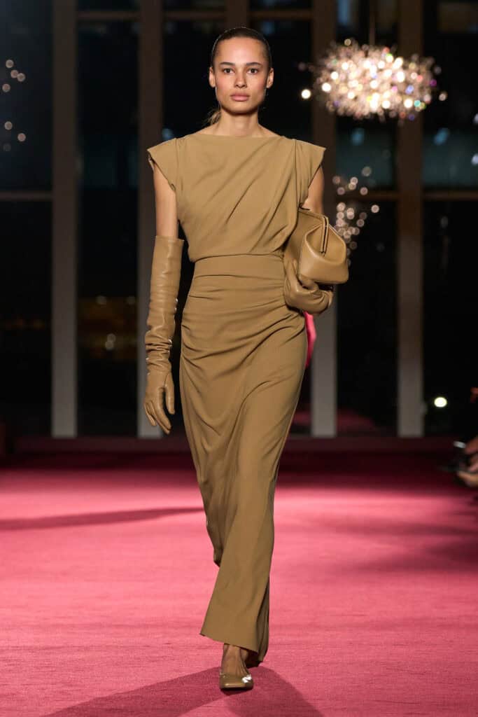 Elegant runway model showcasing Michael Kors Fall/Winter 2026 collection at 45th anniversary event.