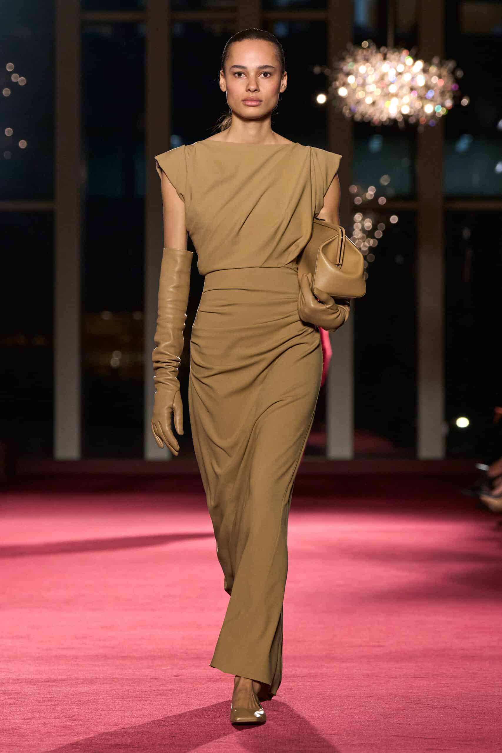Elegant runway model showcasing Michael Kors Fall/Winter 2026 collection at 45th anniversary event.