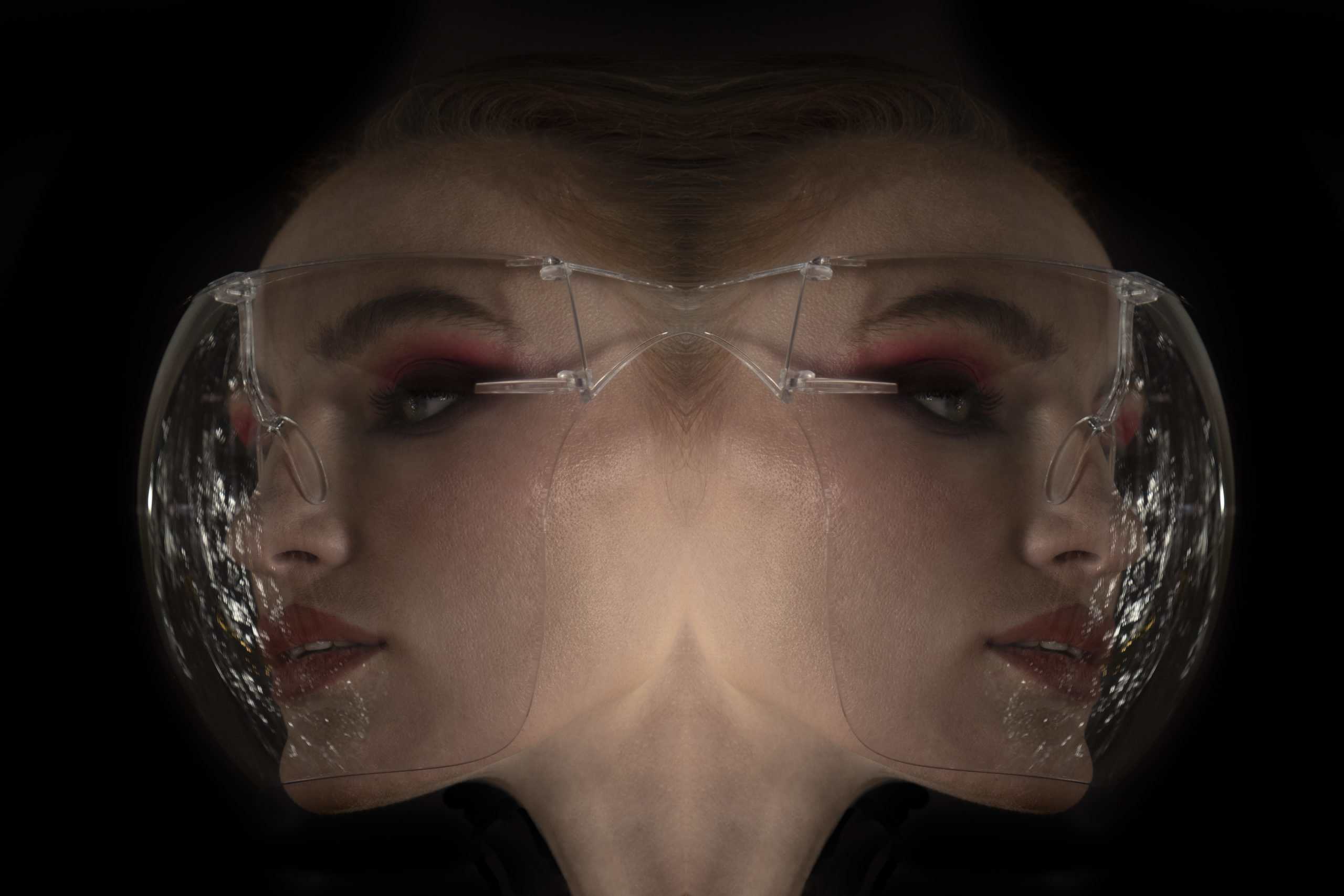 Editorial photoshoot with large transparent glasses on the model's face, which is split in two. 