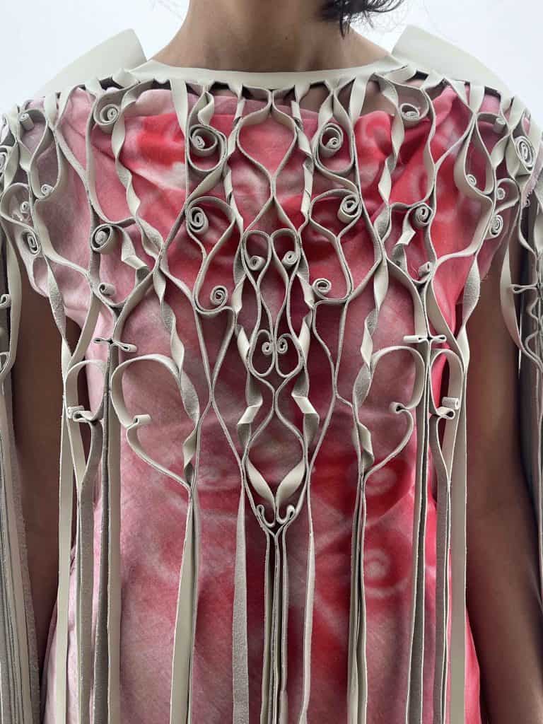 : Detail of two textile techniques by Hannah Smith: knotted rope over dyed silk and pleated white fabric evoking anatomical forms.