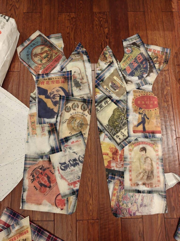 Patterned fabric pieces featuring vintage Chinese and Russian posters printed on translucent textile, prepared for garment construction. Courtesy of designer Chanri Zhao.