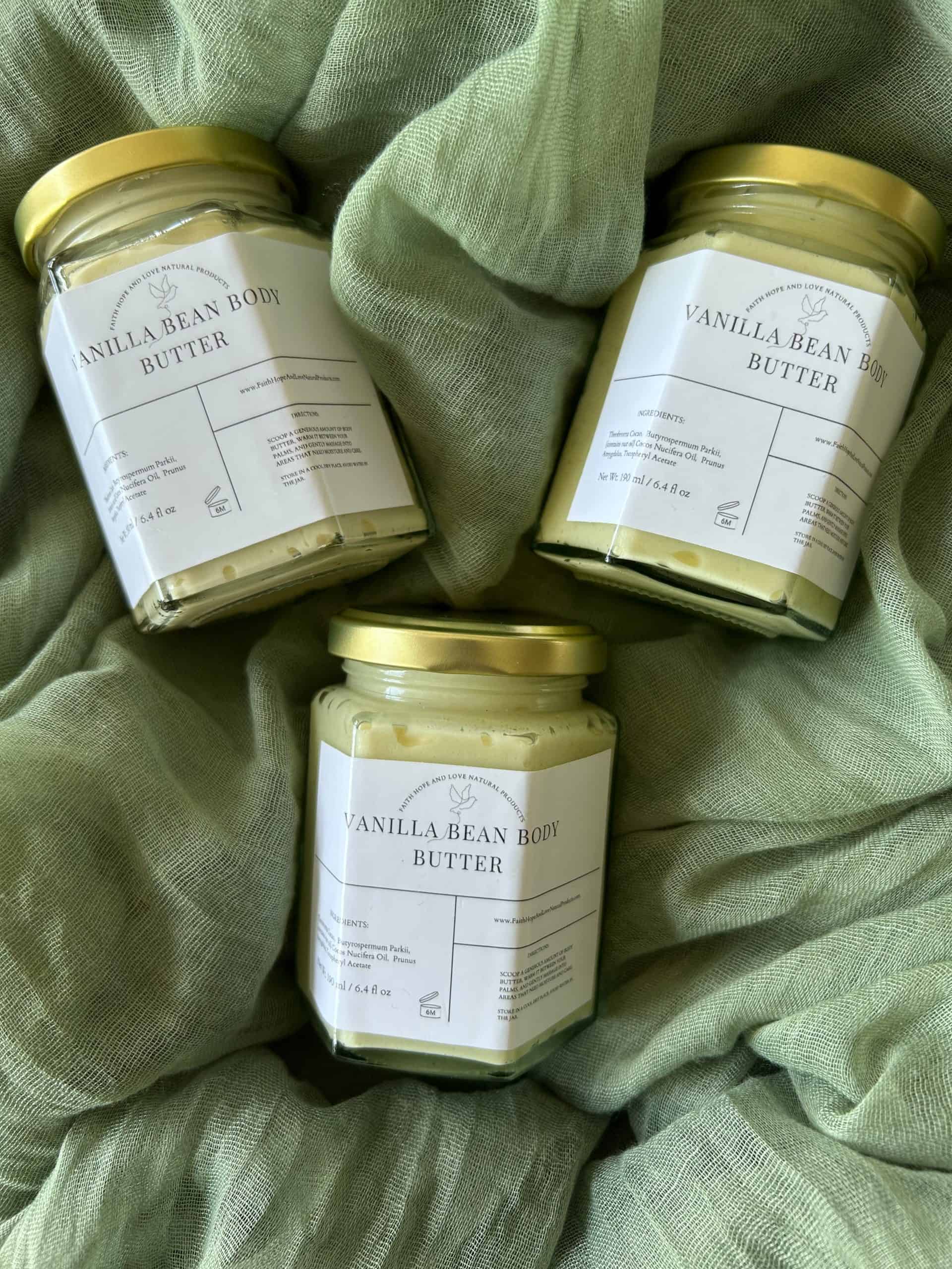 Three jars of Vanilla Bean Body Butter by FHL Natural Products, displayed on a soft green fabric. Courtesy of FHL Natural Products.