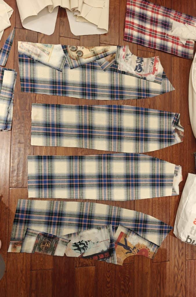 Tartan-cut panels combined with printed motifs referencing cultural archives, laid out for assembly. Courtesy of designer Chanri Zhao.