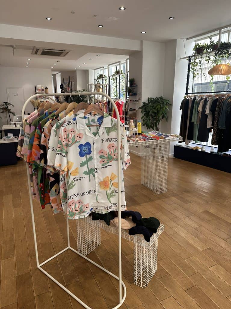 Interior view of Twins Concept Store with lifestyle items, accessories, and a central display table in a bright, inviting space.