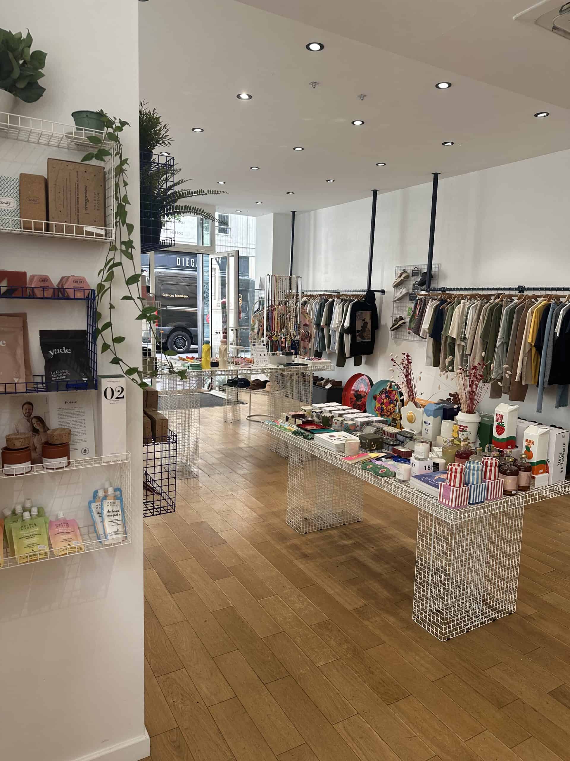 Clothing racks and curated fashion items inside Twins Concept Store in Paris, showcasing a modern and modular boutique layout.