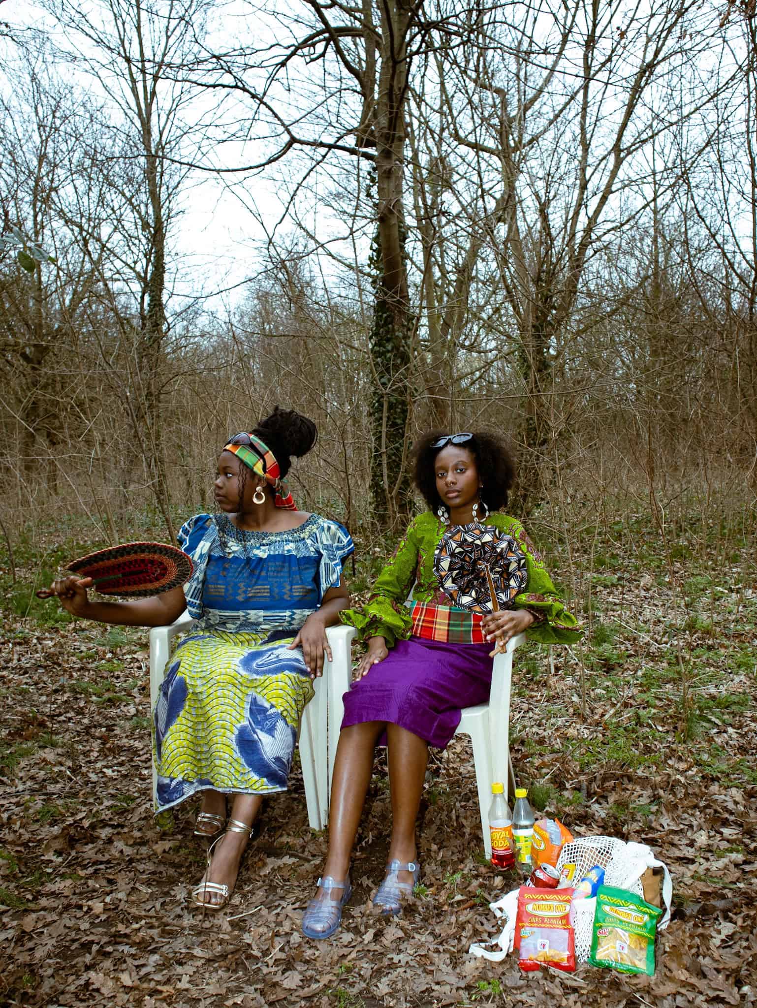 Two women sit side by side, blending traditions from Guadeloupe and Congo. Therefore, the scene feels both intimate and universal. "POINTE-NOIRE"