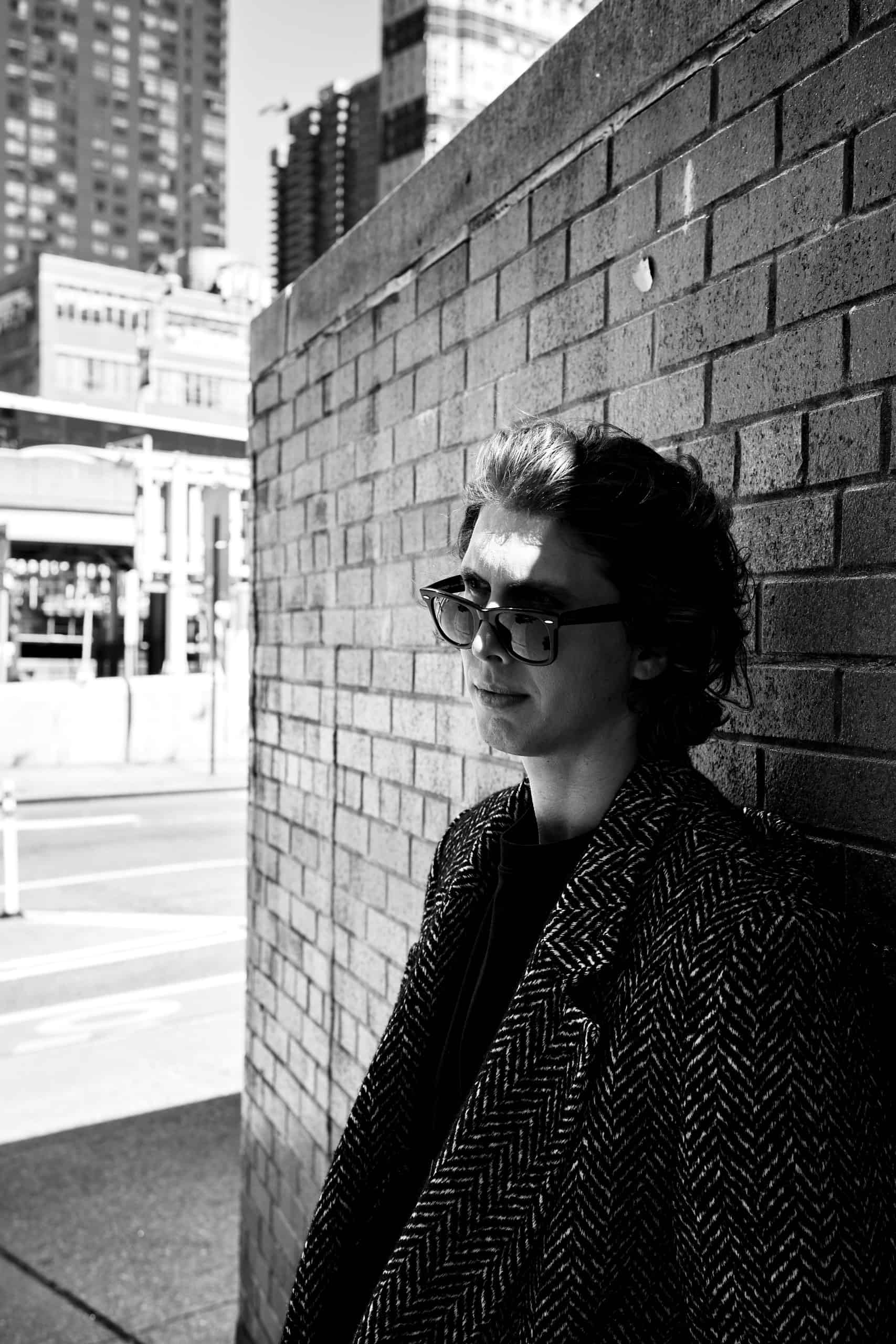 Andrew Boszhardt photographed by Van Strahl, styled by Clay Dealy. Creative direction by Cannon. A cinematic street portrait that reflects the noir mood of Breed of Greed.