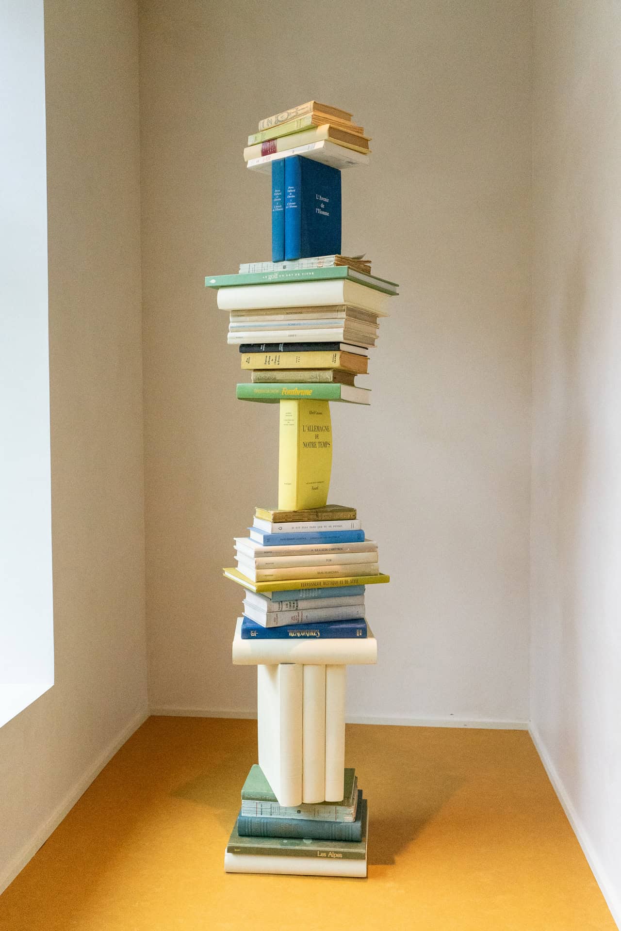 Tower of stacked books inside Off-Campus Paris.