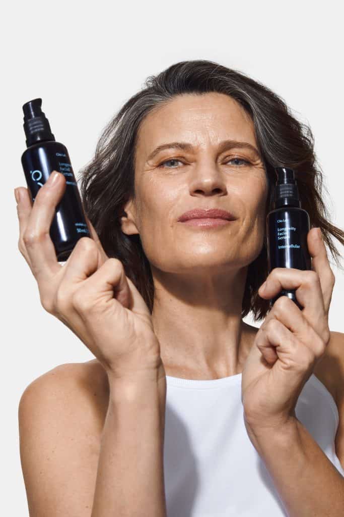 Holding the Intercellular serum from Oio Lab – clean beauty meets summer skin needs.
