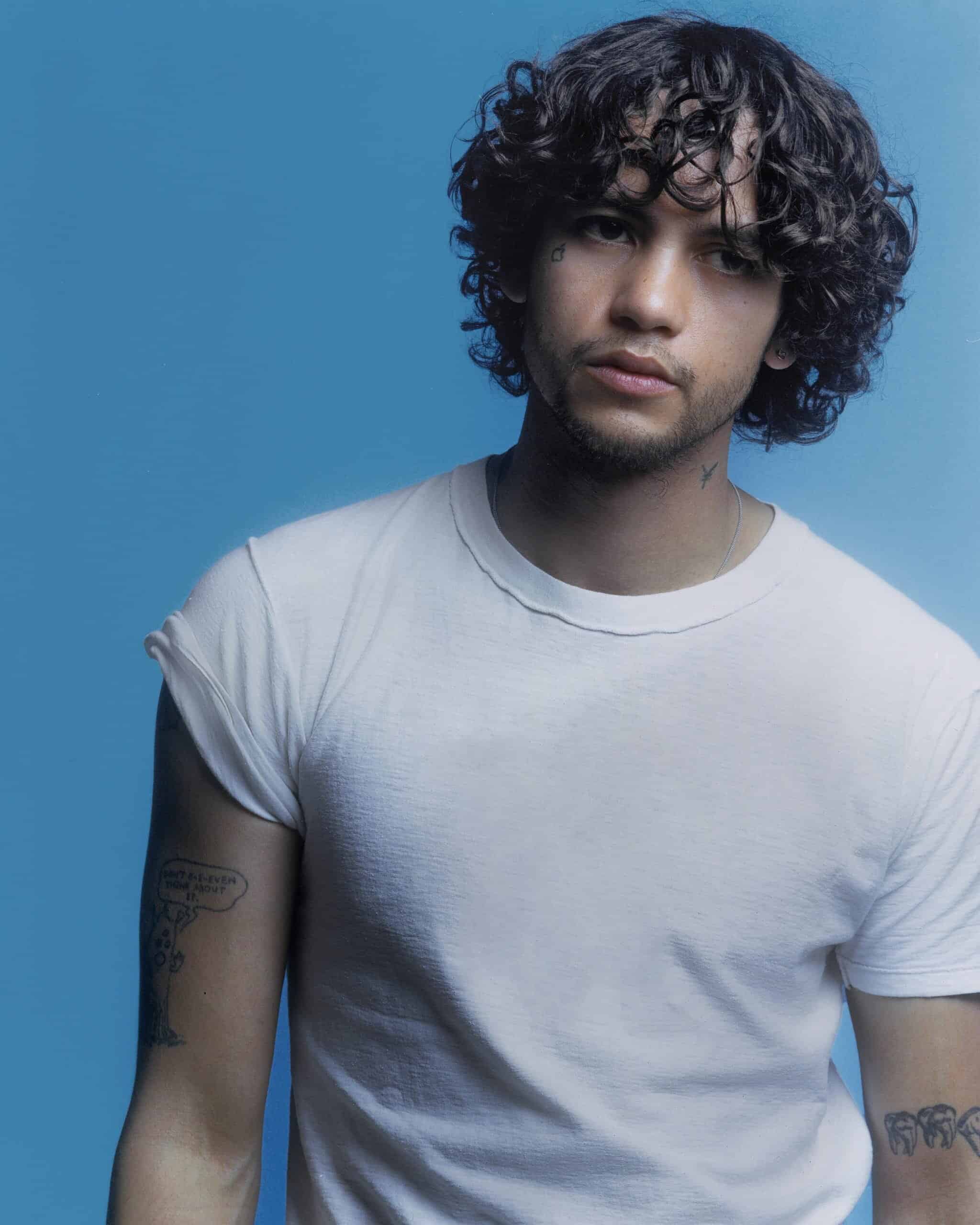 Cover Dominic Fike in front of a blue light background
