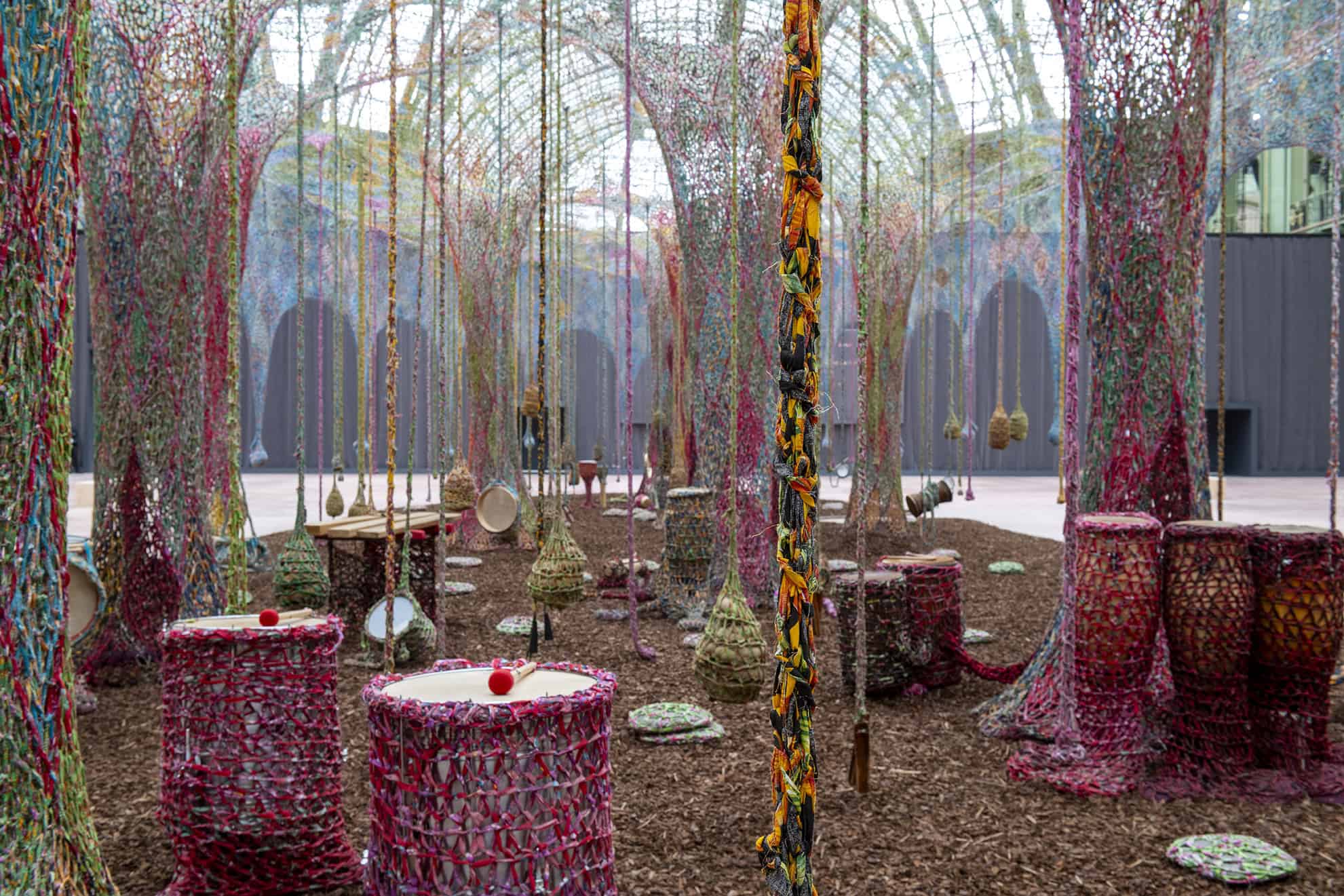 Drums and woven elements suspended in Ernesto Neto’s immersive installation Nosso Barco Tambor Terra at the Grand Palais, June 2025. Courtesy of FINN Partners.