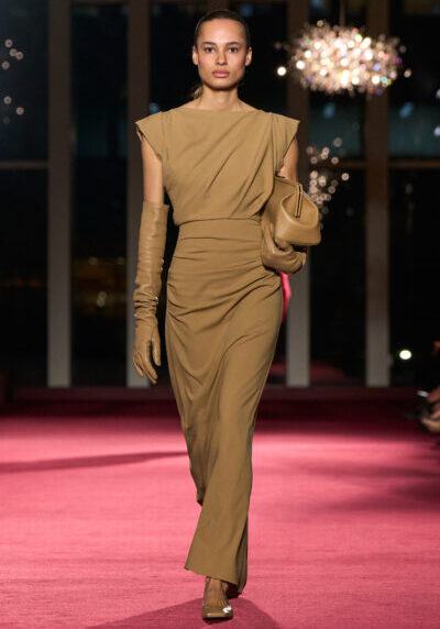 Elegant runway model showcasing Michael Kors Fall/Winter 2026 collection at 45th anniversary event.