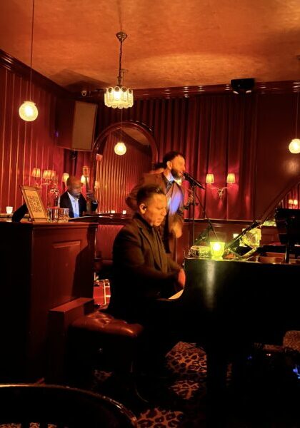 Jazz live performance at cozy bar with pianist and singer, warm ambient lighting, intimate music setting, perfect for relaxing evenings.