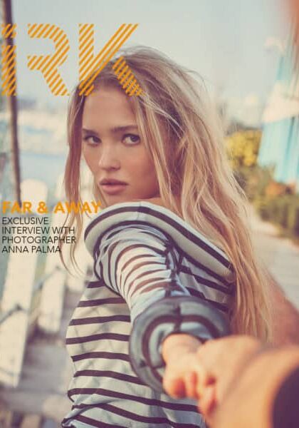 Anna Palma taking a selfie outdoors on a sunny day, promoting her feature in IRK Magazine.