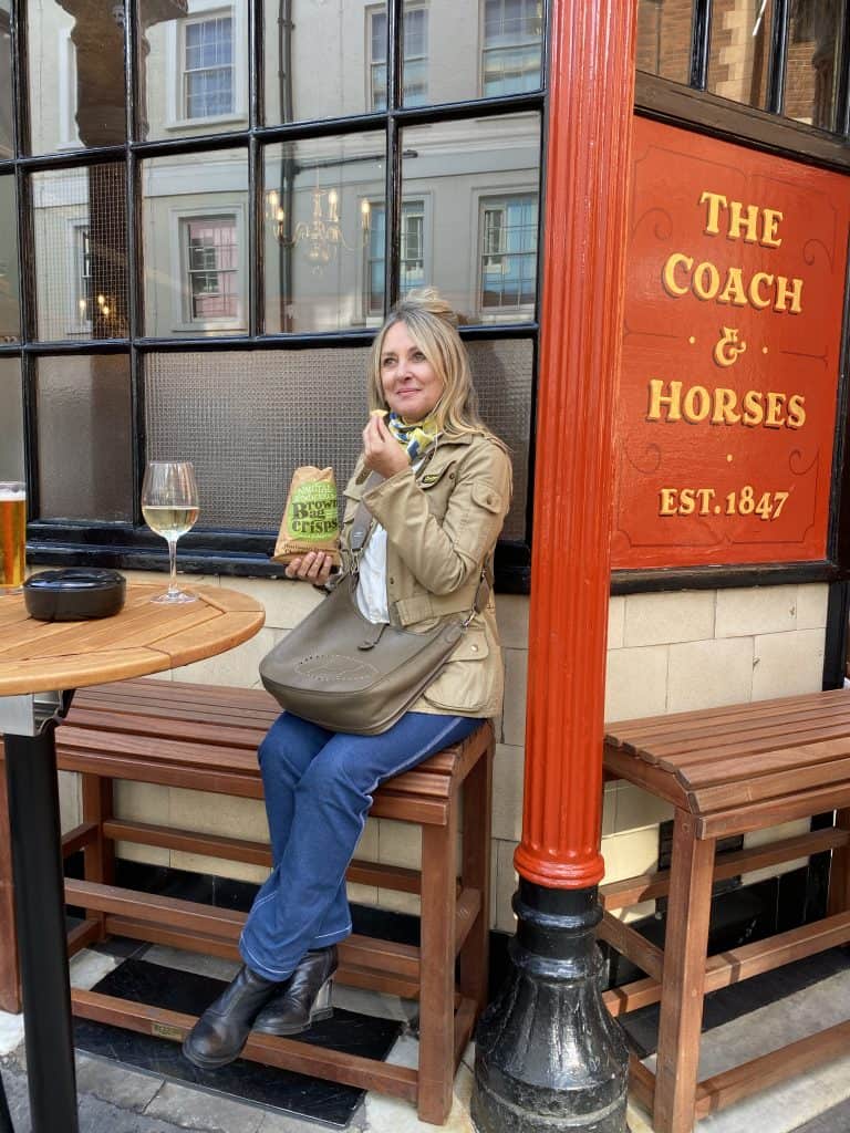 Anji Connell sitting outside the Coach and Horses