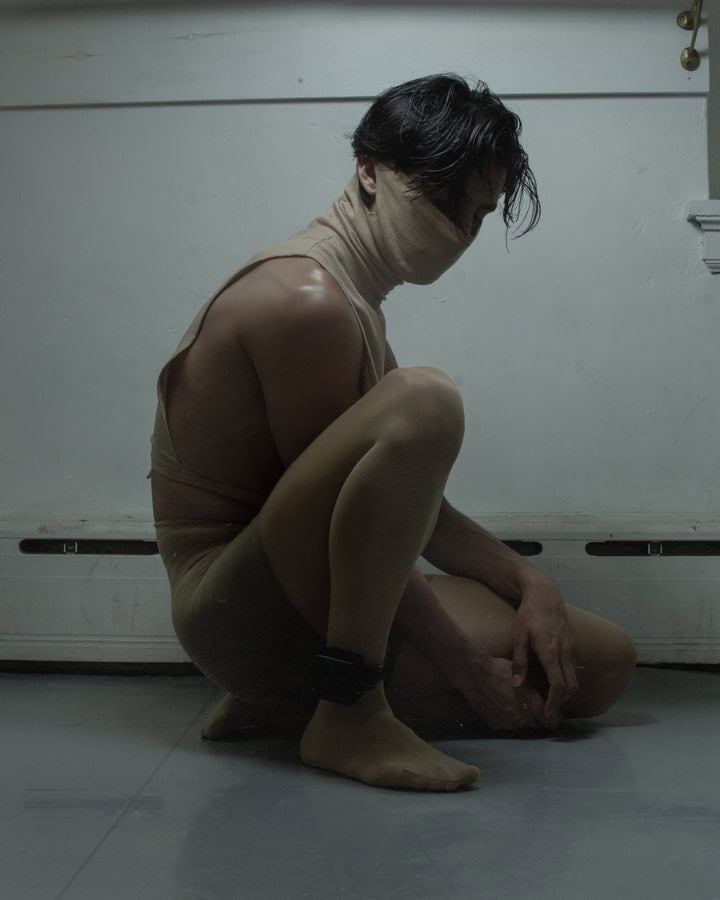 Dancer wearing a face cover as part of his dance outfit