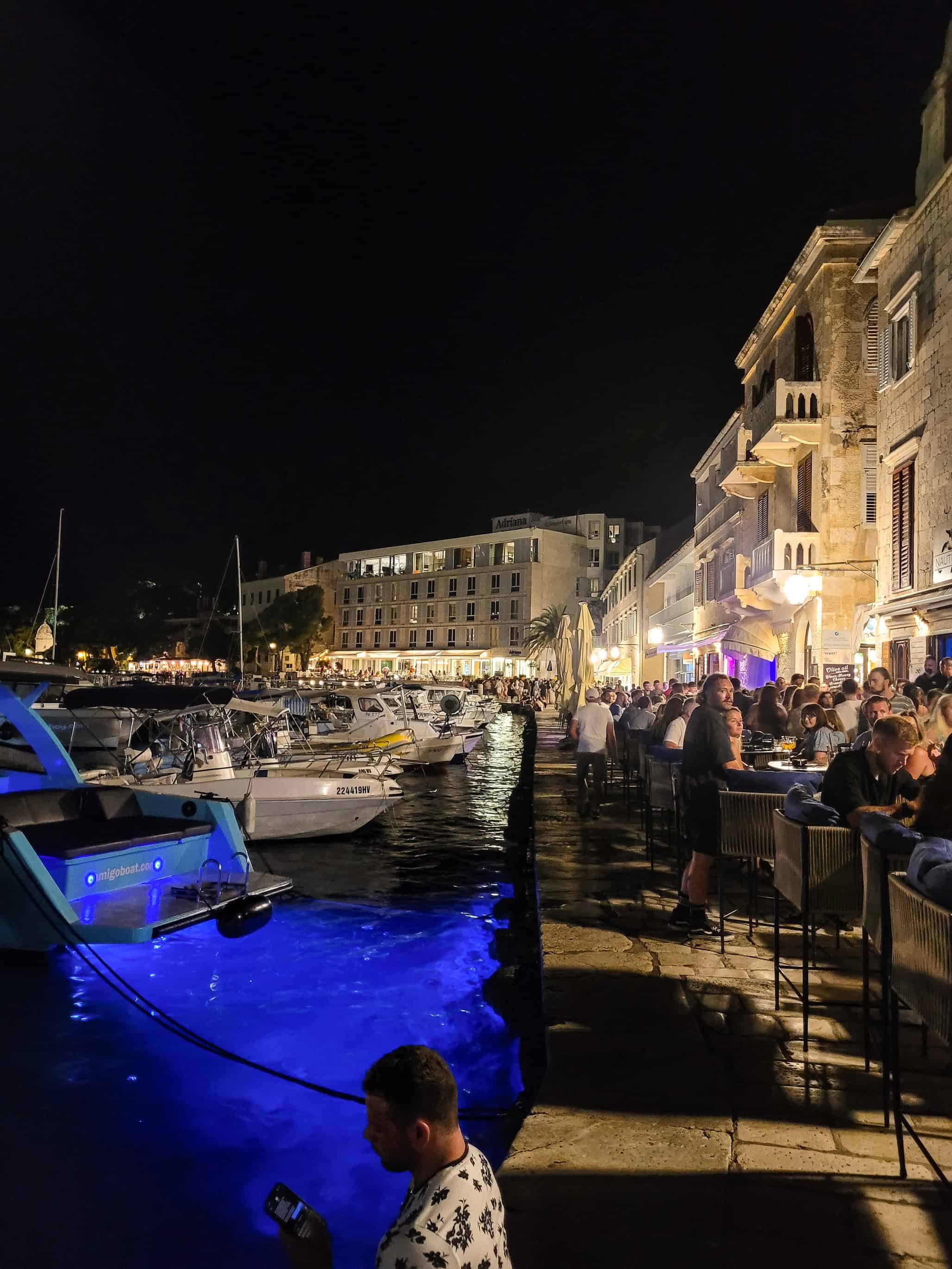 color landscape photograph of boat in marina at night