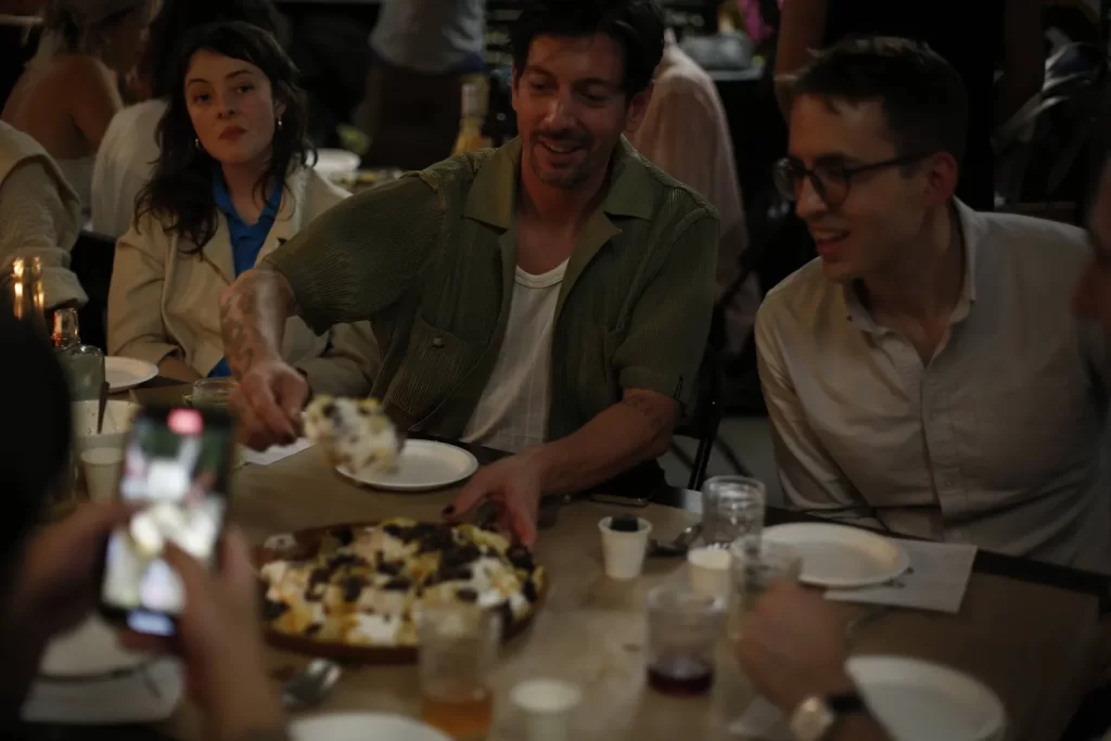 Friends sitting around the dinner table about to eat their first course of mushrooms 