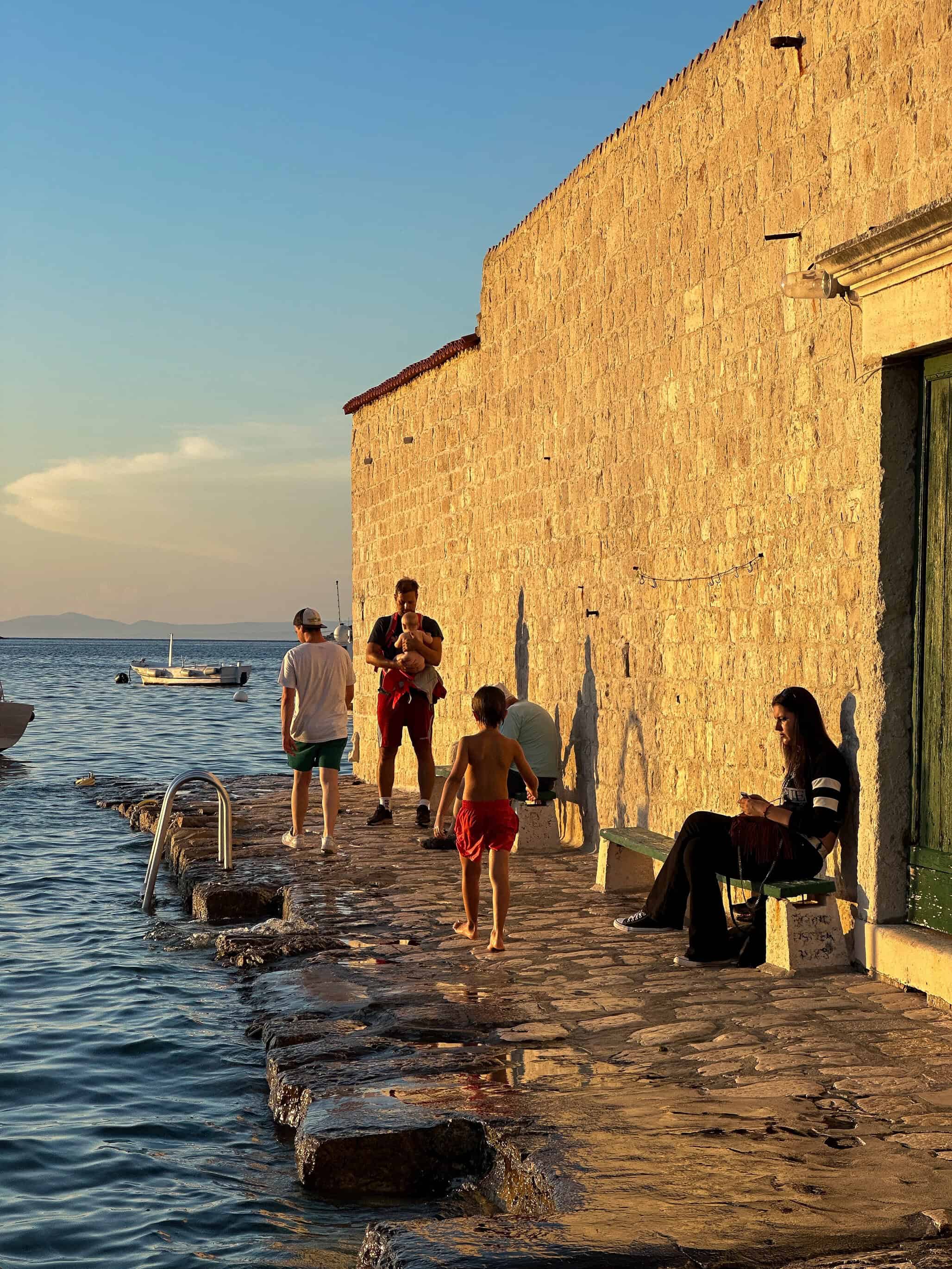 color portrait photograph of people by sea at sunset