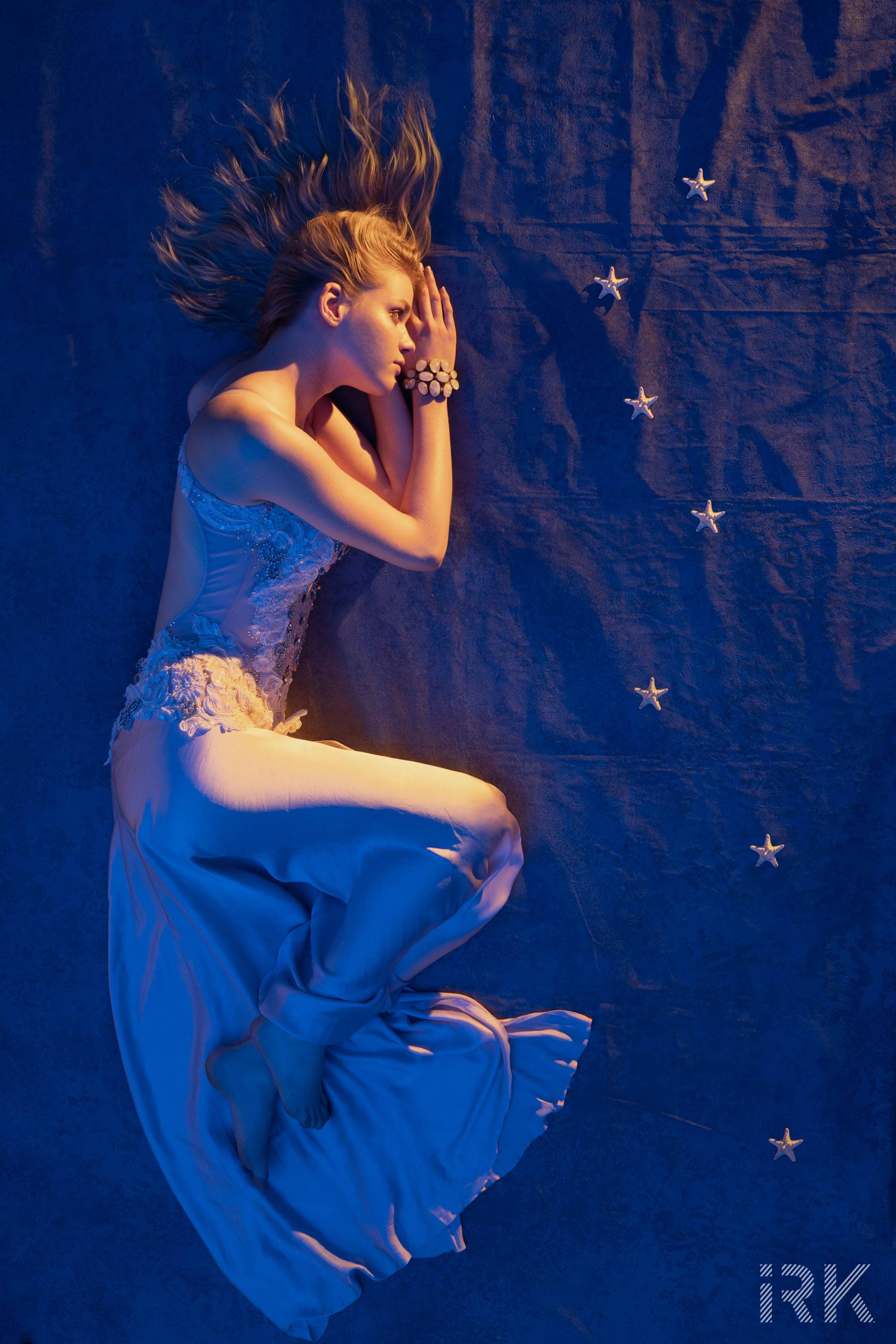 In a night sky fashion editorial. Silk embroidered dress Zvonko Markovic Couture, Opal bracelet Suna Moya Sea stars from Alexandre Import Nature