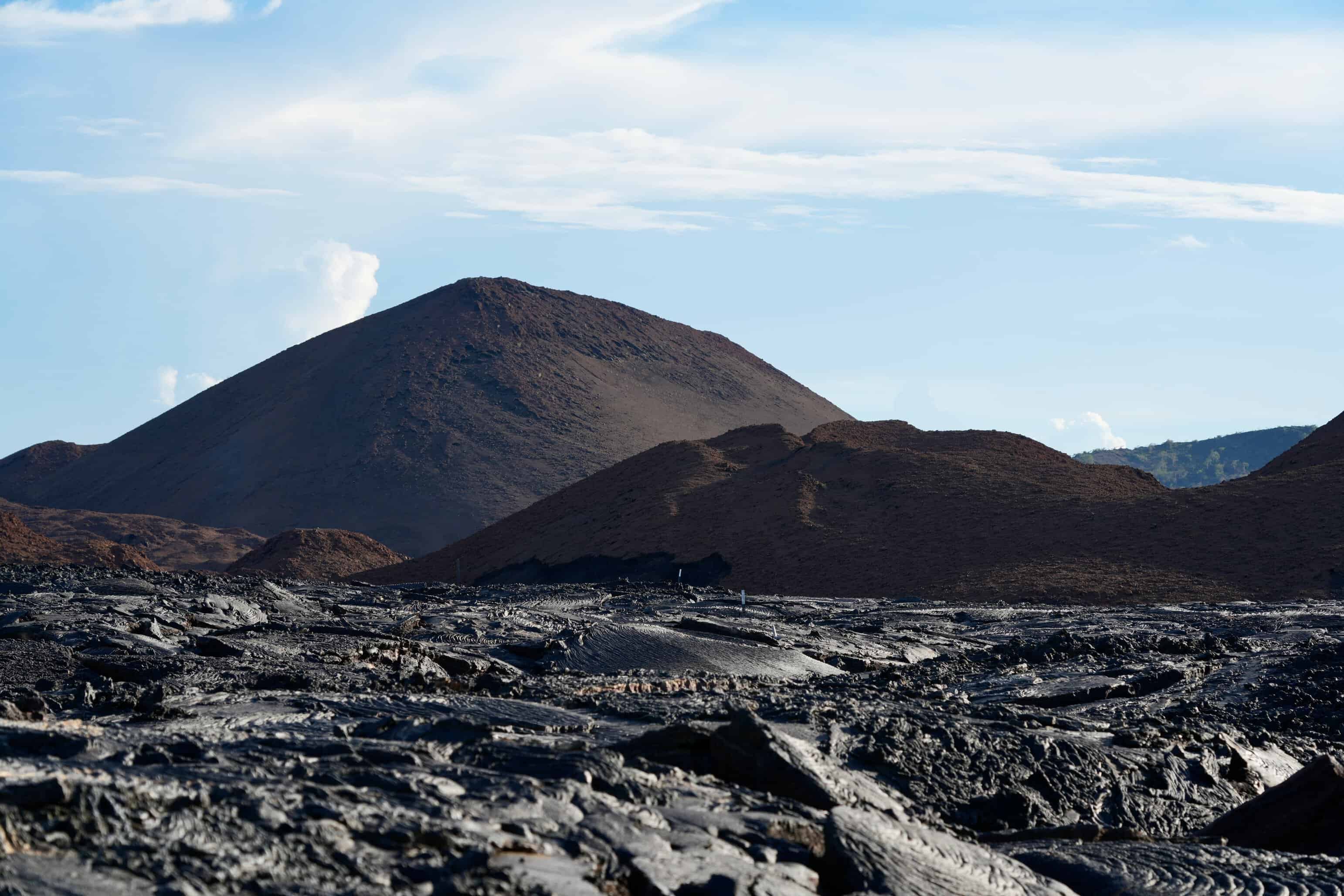 Galápagos Volcanic mountain surrounded by lava fields and rugged terrain, showcasing natural geological format.
