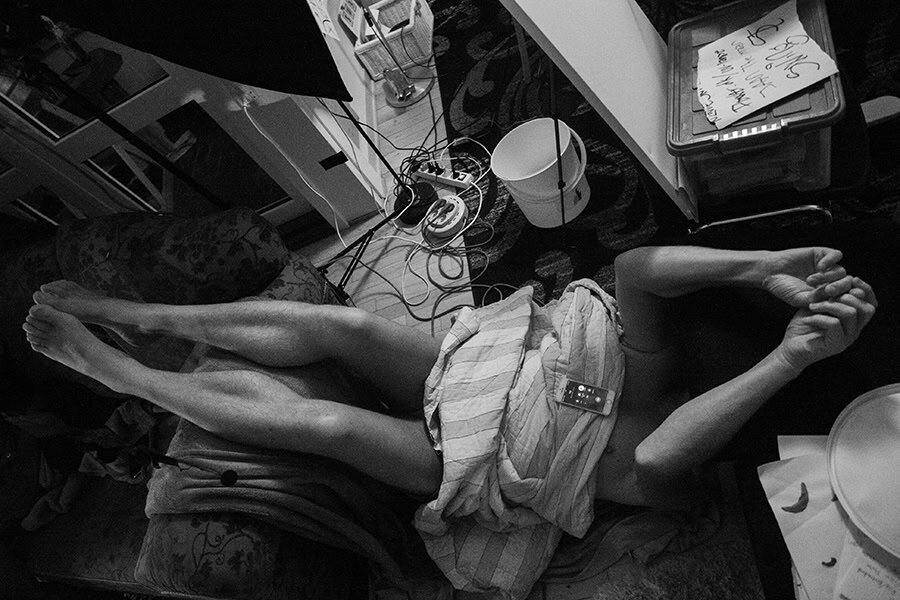 Person stretching out on the floor by Tim Bertram