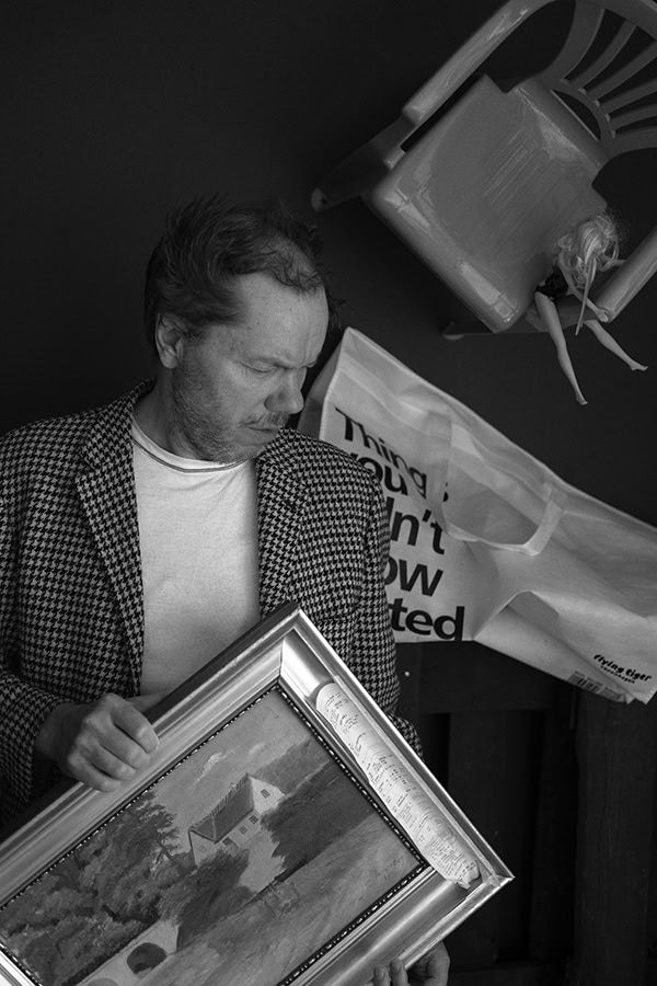 Man holding framed picture by Tim Bertram