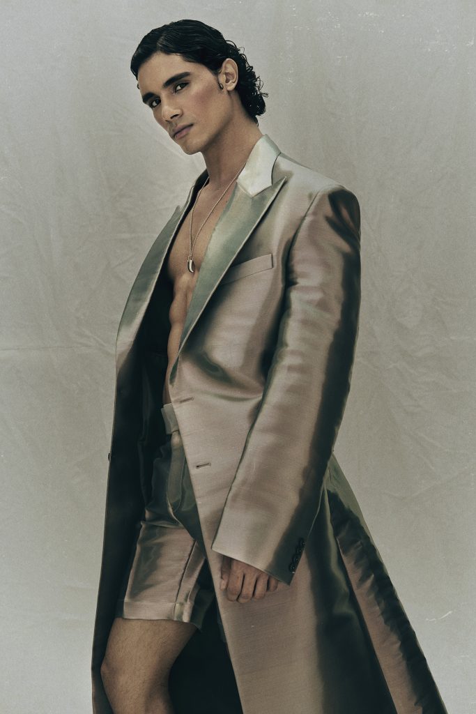  wearing metallic blazer with long cut, expressive stance, Eternal Allure photo story by Ben Cope.