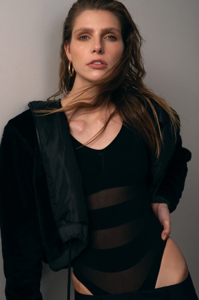 black-and-white checkered jacket layered over lingerie, bold fashion look.