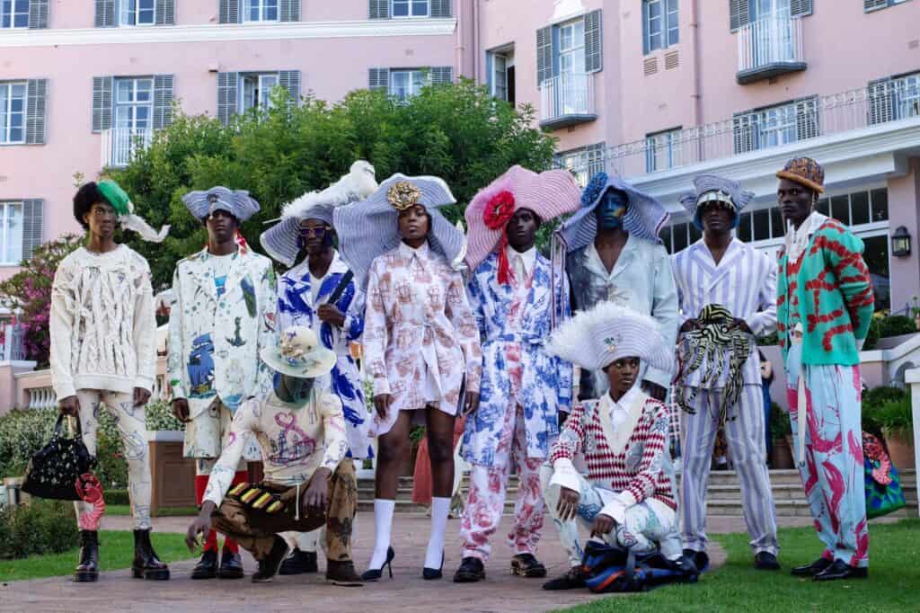 Colorful fashion models with parasols at Mount Nelson Hotel in Cape Town.