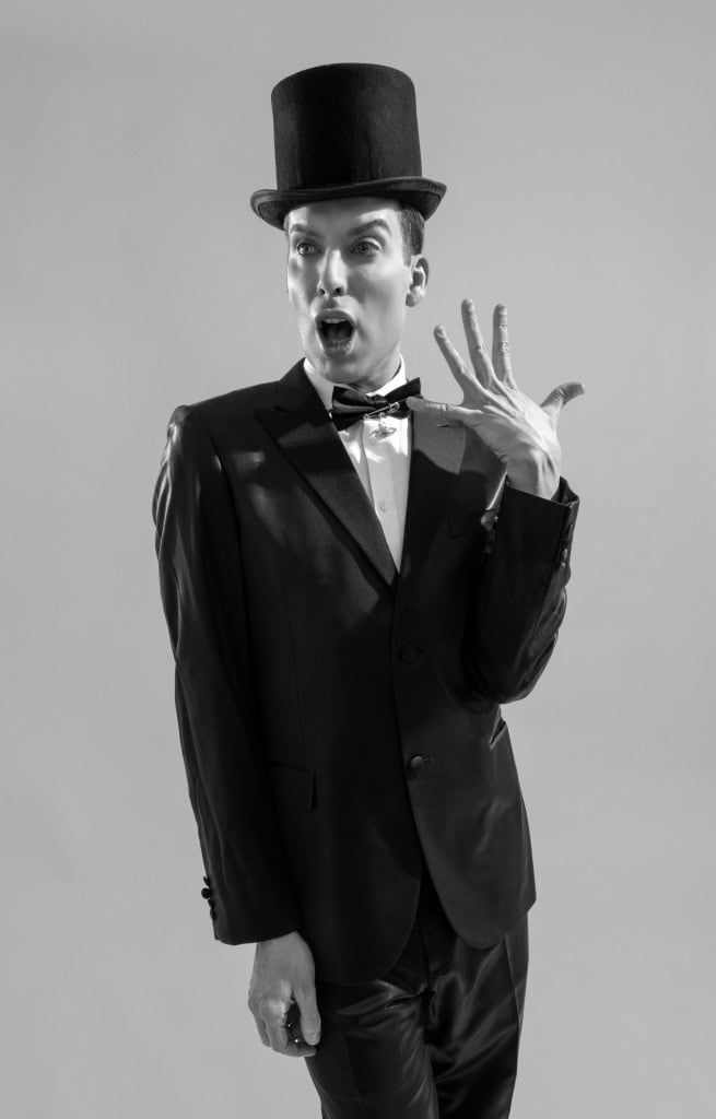 Alaska in Black Suit: Calvin Klein, Bow Tie: Gucci, Hat: Binata Millinery, Mask: Erickson Beamon from Showroom SEVEN Millinery Erickson Beamon from Showroom SEVEN Pleaser, Shoes Pleaser. 