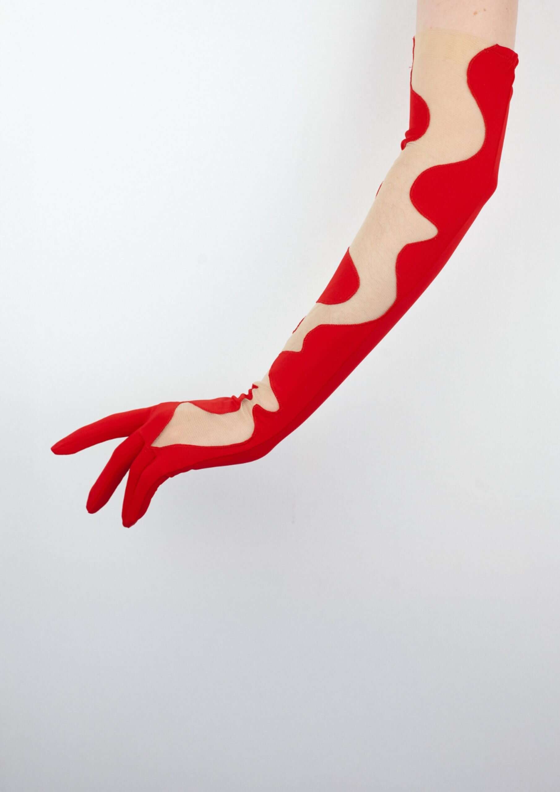 Katja glove by C'est Jeanne, with bright opaque red and see-through material 
