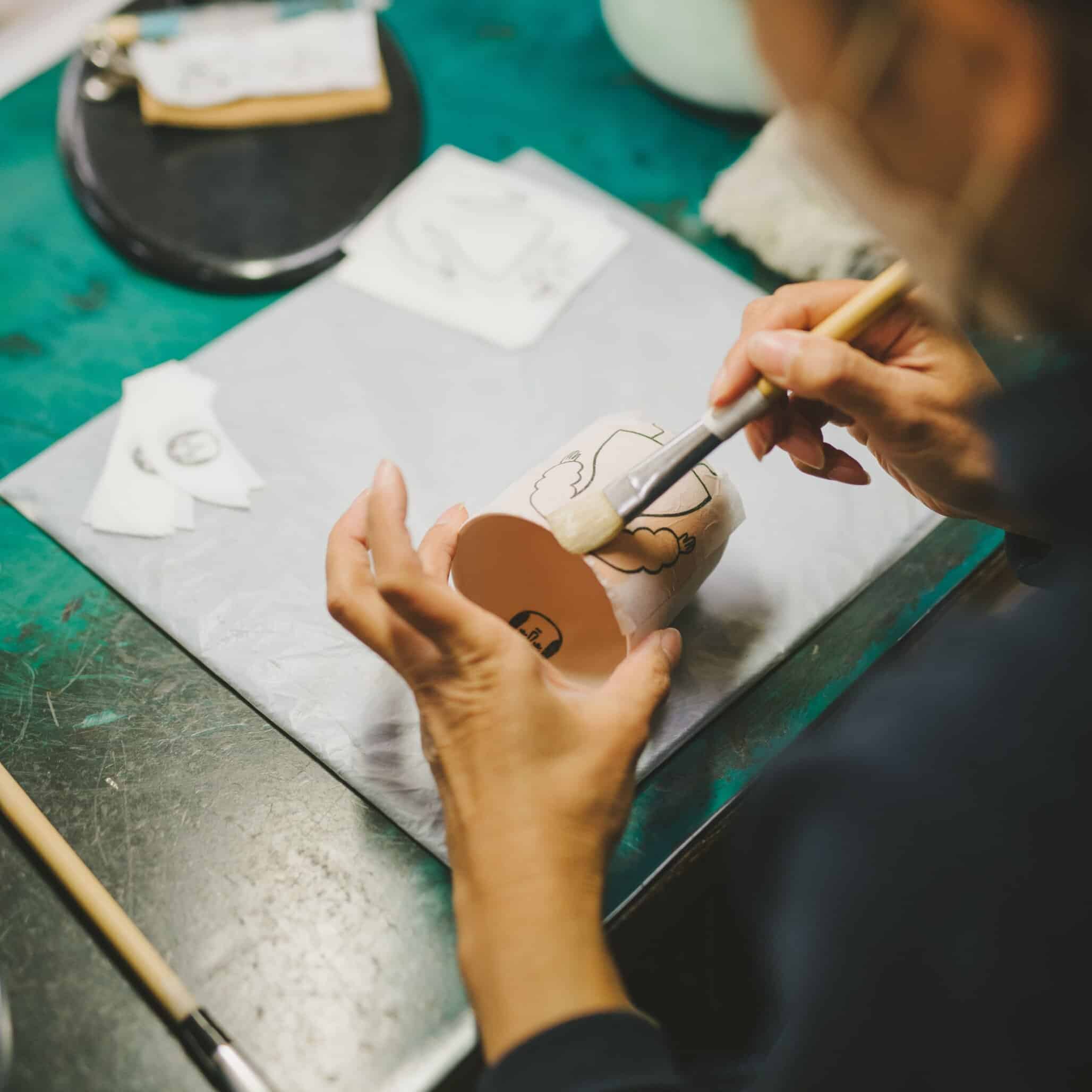 Hand-painted motif applied with a brush onto a Ko-sometsuke porcelain cup designed by Amélie Fontaine.